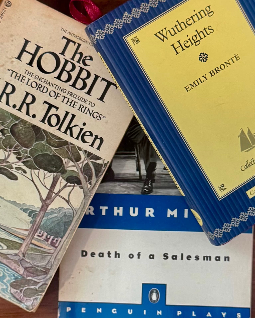 A collection of three books: 'The Hobbit' by J.R.R. Tolkien, 'Wuthering Heights' by Emily Brontë, and 'Death of a Salesman' by Arthur Miller.
