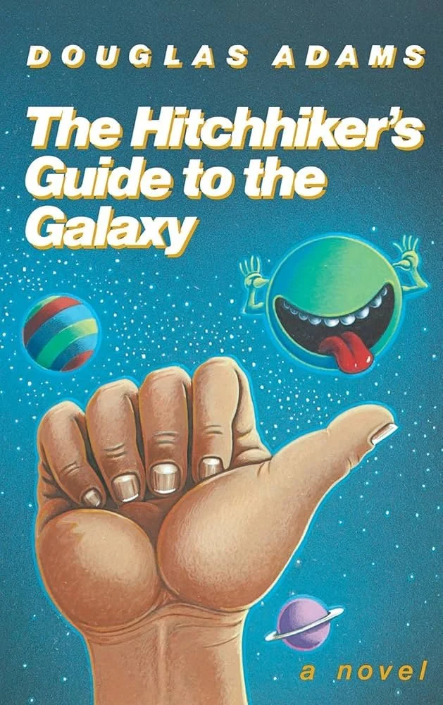 Cover of the book "The Hitchhiker's Guide to the Galaxy" by Douglas Adams. Features a blue background with stars, a large hand making a thumbs-up gesture, a colorful planet, a green smiling cartoon planet sticking out its tongue, and a purple ringed planet. The title and author's name are in bold, yellow-and-white text.
