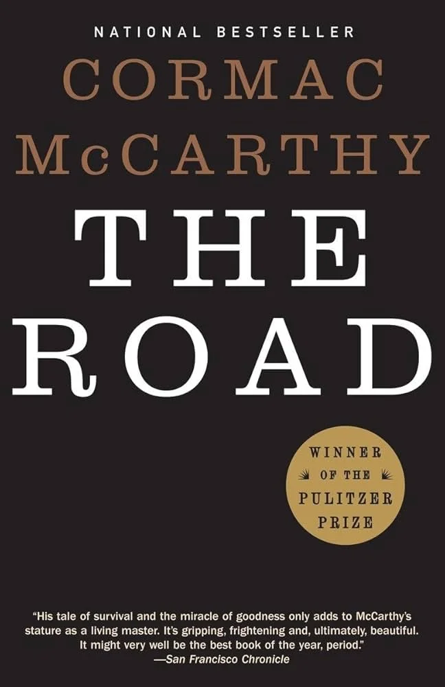 The cover of the book 'The Road' by Cormac McCarthy featuring the author's name, title, and a quote about the book.