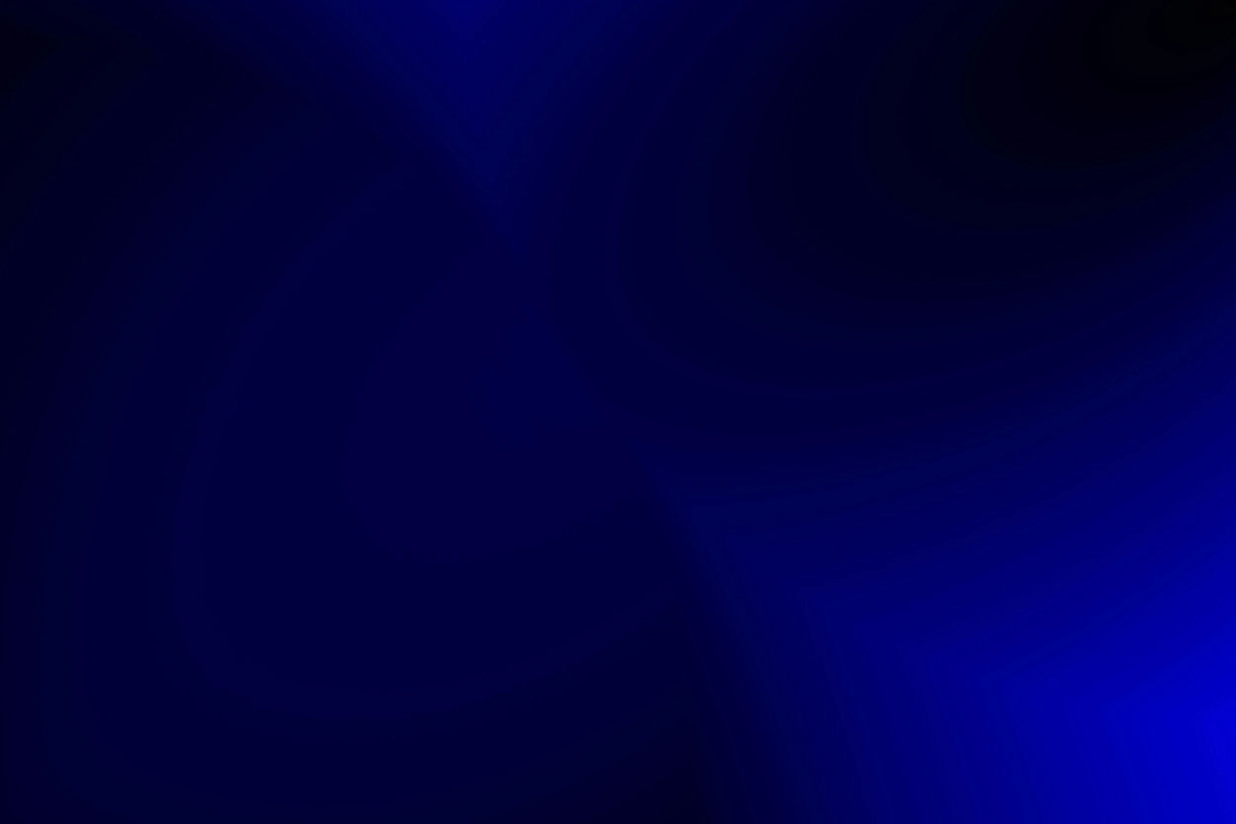 Dark blue background with gradient, no distinct objects or features visible.