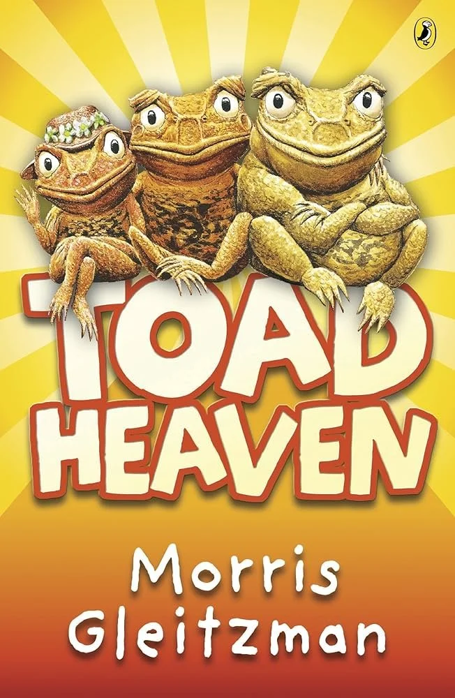 Book cover for 'Toad Heaven' by Morris Gleitzman featuring three cartoon toads with human-like expressions and hands, sitting in front of a yellow background with rays, and a logo in the top right corner.