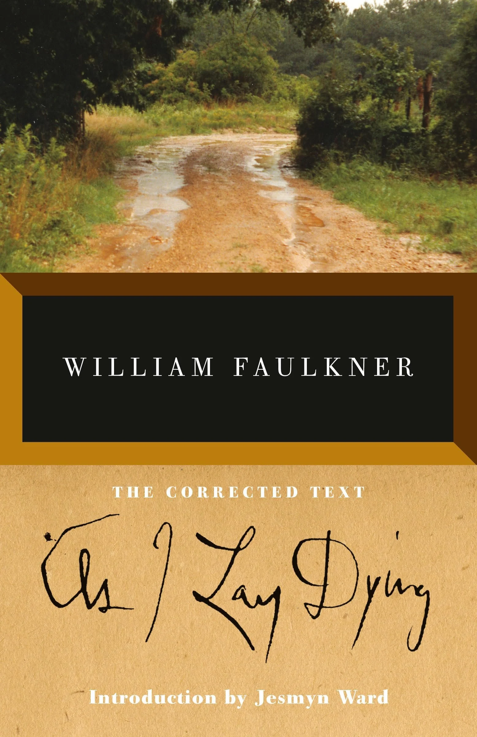 Book cover titled 'William Faulkner: The Corrected Text' with an introduction by Jesmyn Ward. The cover features a photograph of a muddy dirt road surrounded by greenery.