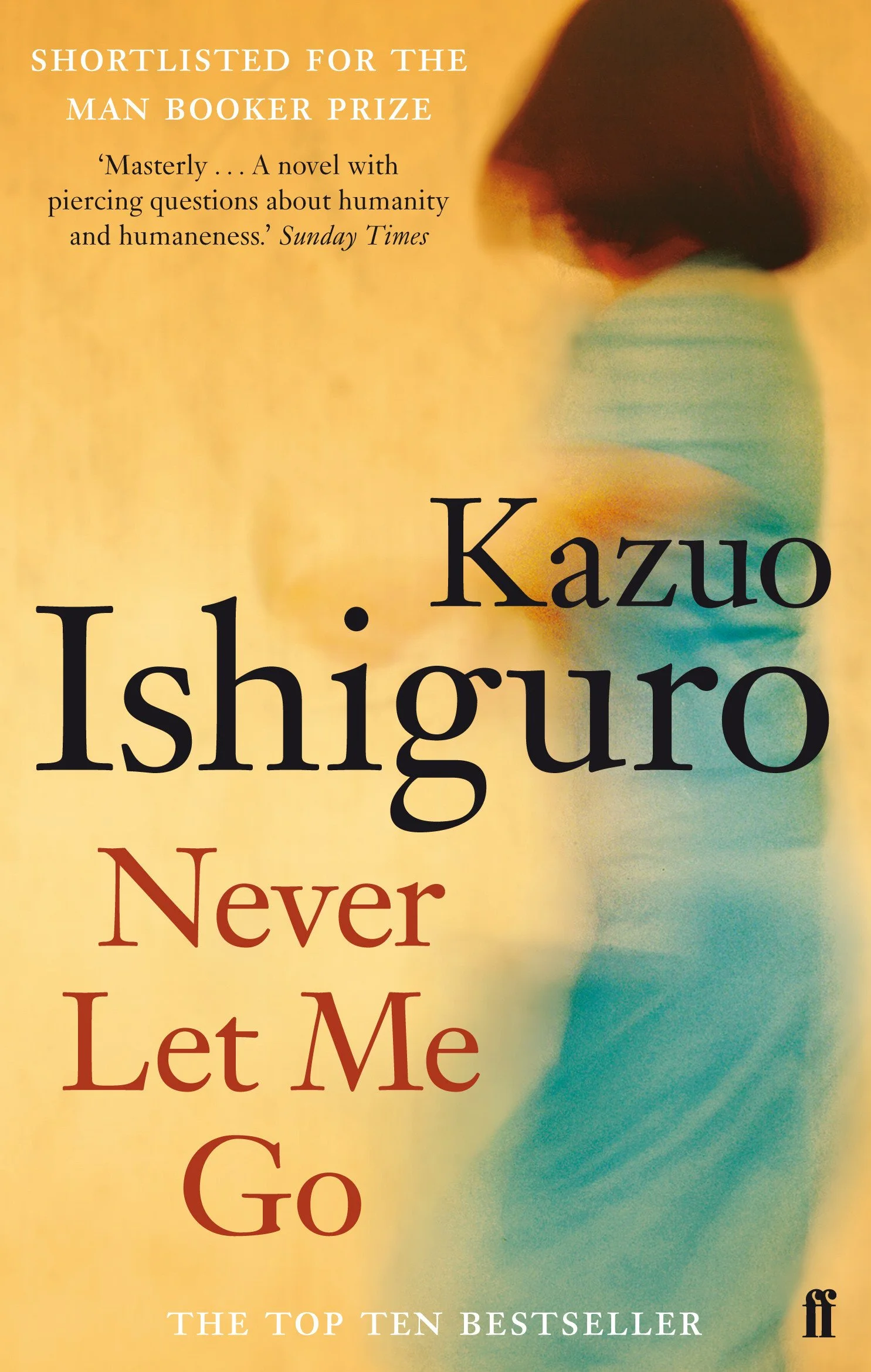 Book cover of "Never Let Me Go" by Kazuo Ishiguro with a blurred background featuring a person wearing a striped shirt and dark hair. Text indicates the book is shortlisted for the Man Booker Prize and describes it as a novel with piercing questions about humanity.