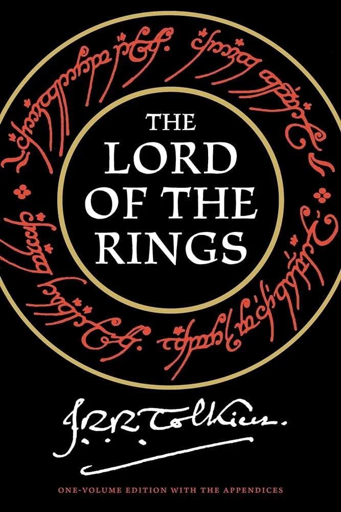 Book cover of 'The Lord of the Rings' by J.R.R. Tolkien. It features a black background with a circular design. Inside the circle, the title is in large white letters. Surrounding the circle is red Elvish script, and below is a white signature of J.R.R. Tolkien. At the bottom, it states 'one-volume edition with the appendices' in red.