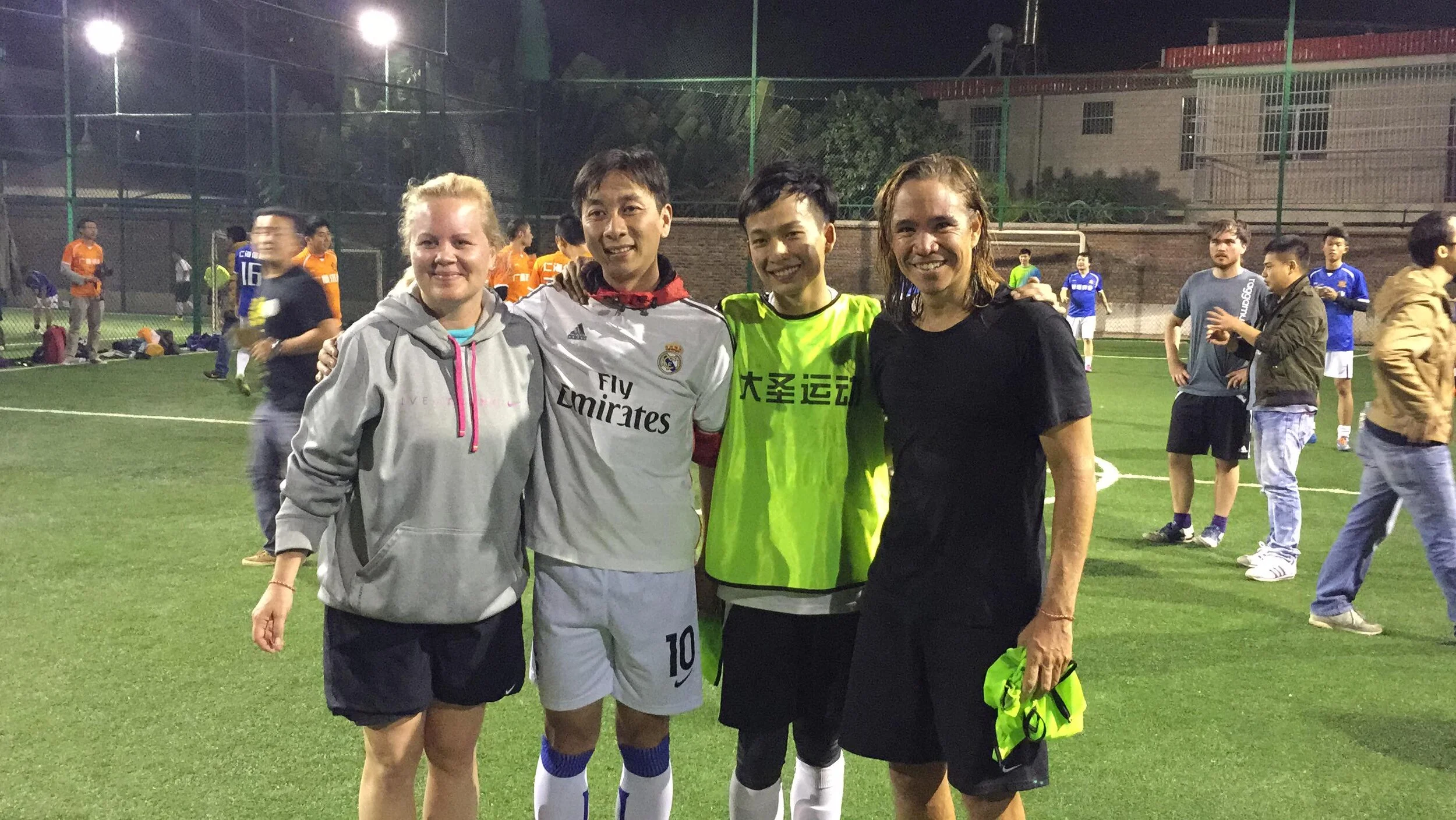Jim and Jennie Powell, iU Founders. Pictured with two of their young trainees and soccer exchange program students - Jason Deng and Dan Zhou - both proficient players, coaches, and leaders in their own right today.
