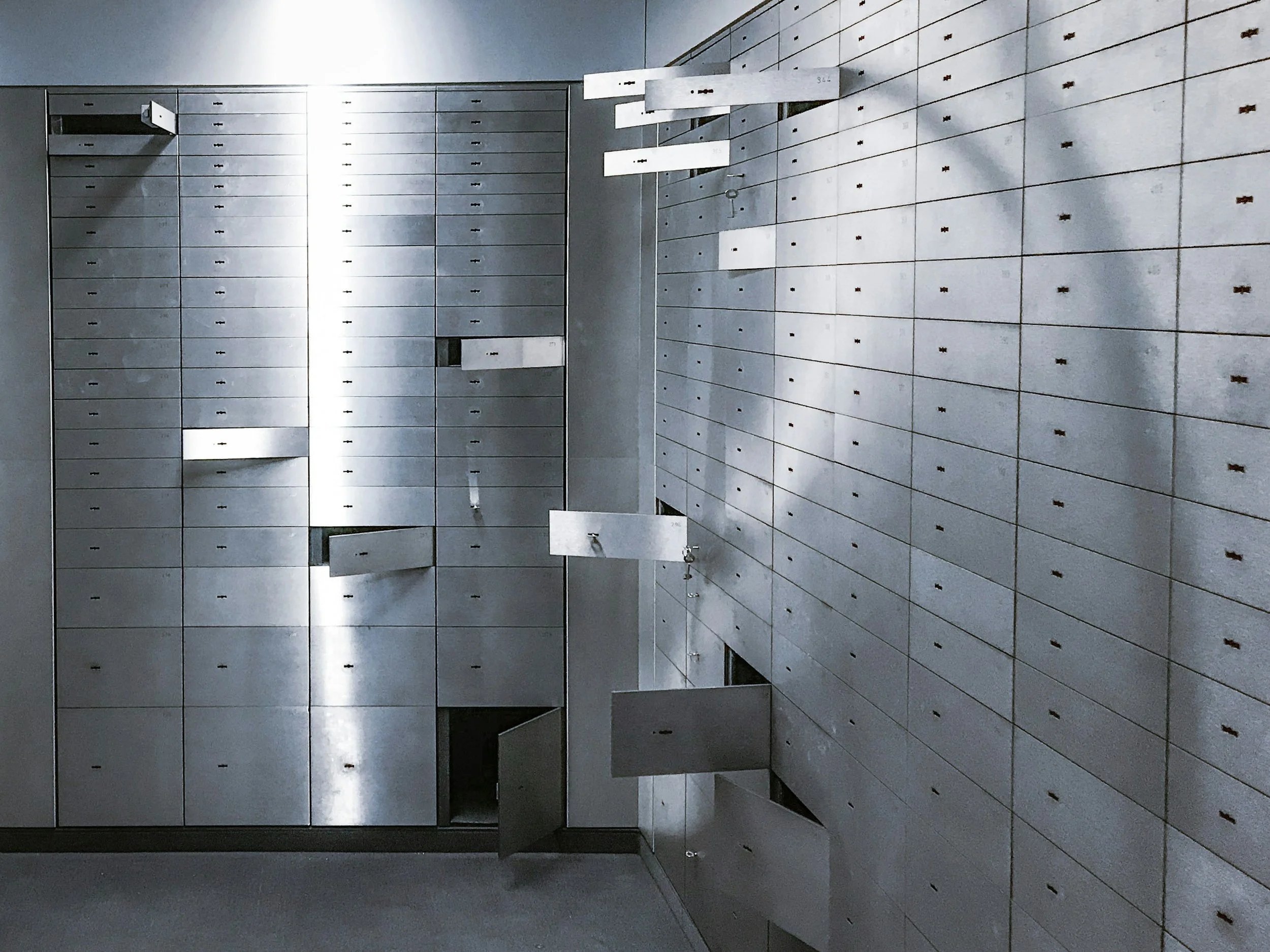 A large set of gray metal lockers in a room of storing valuables. We do offer safe moving support.