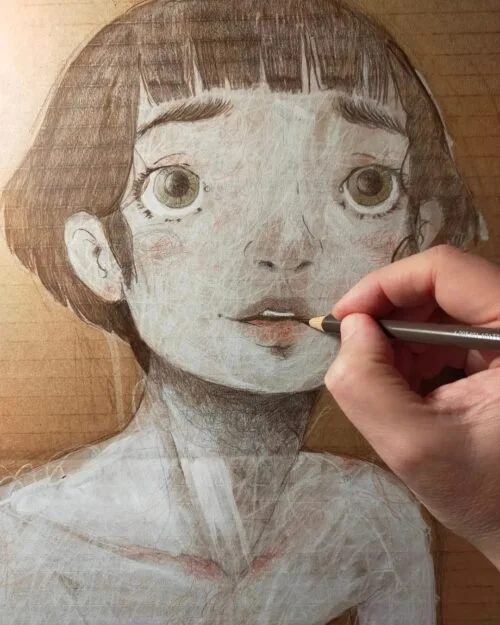 Diego Gabriele drawing a realistic portrait of a young girl with large eyes, short dark hair, and a gentle expression on a brown textured surface.