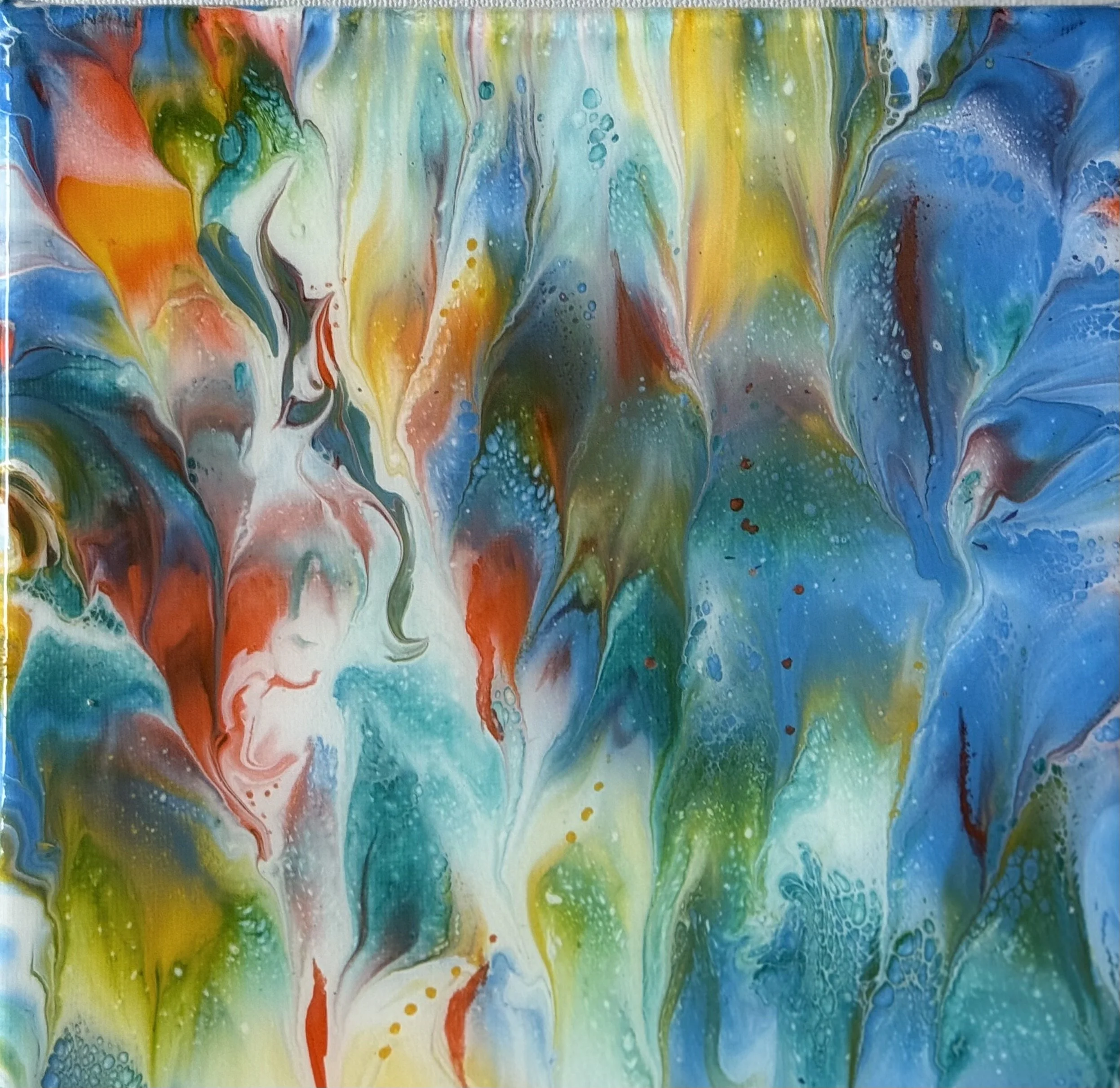 Abstract watercolor painting with flowing streaks of blue, green, yellow, orange, pink, and red colors blending together.