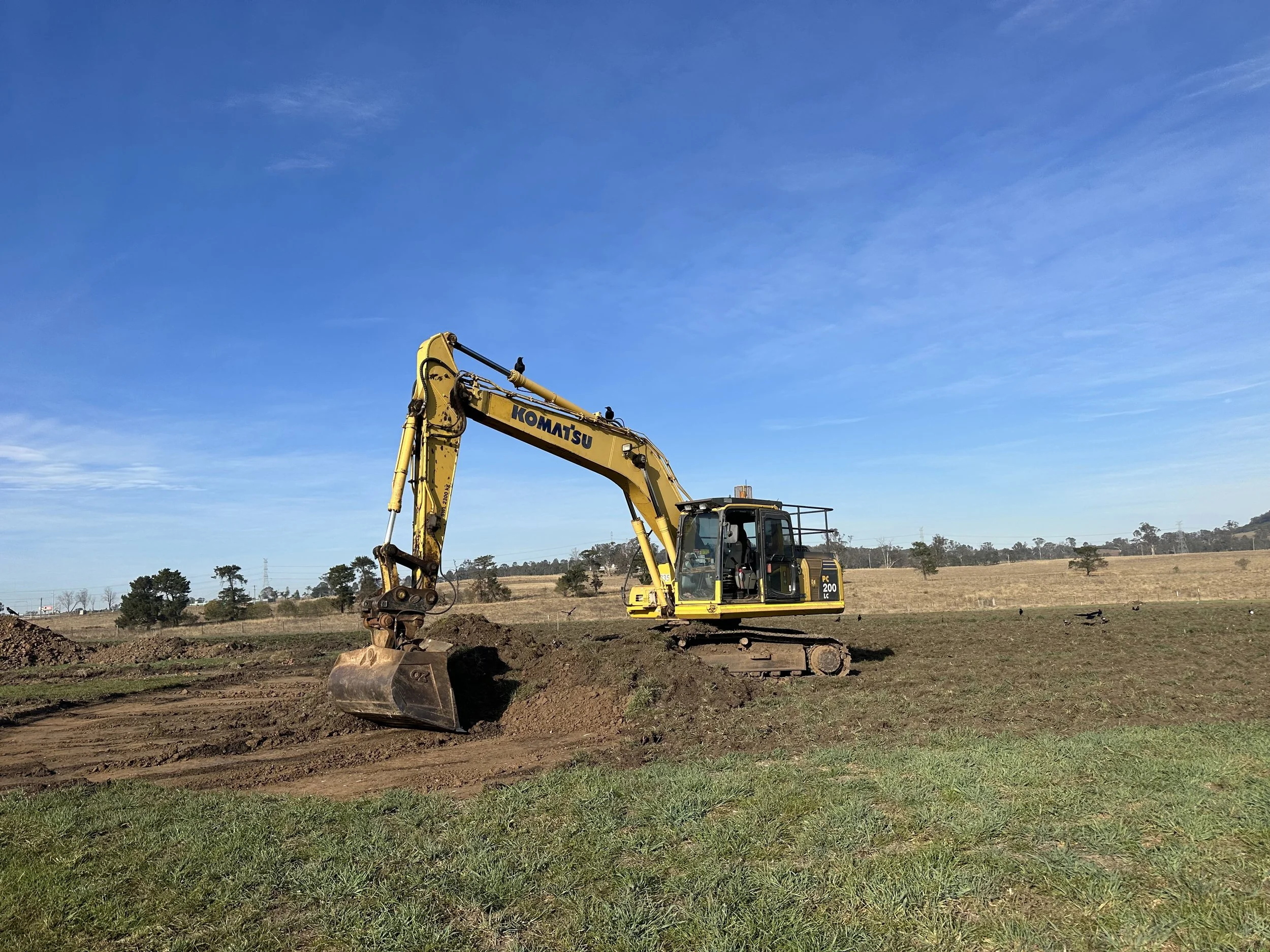 Excavator performing site cut for construction preparation