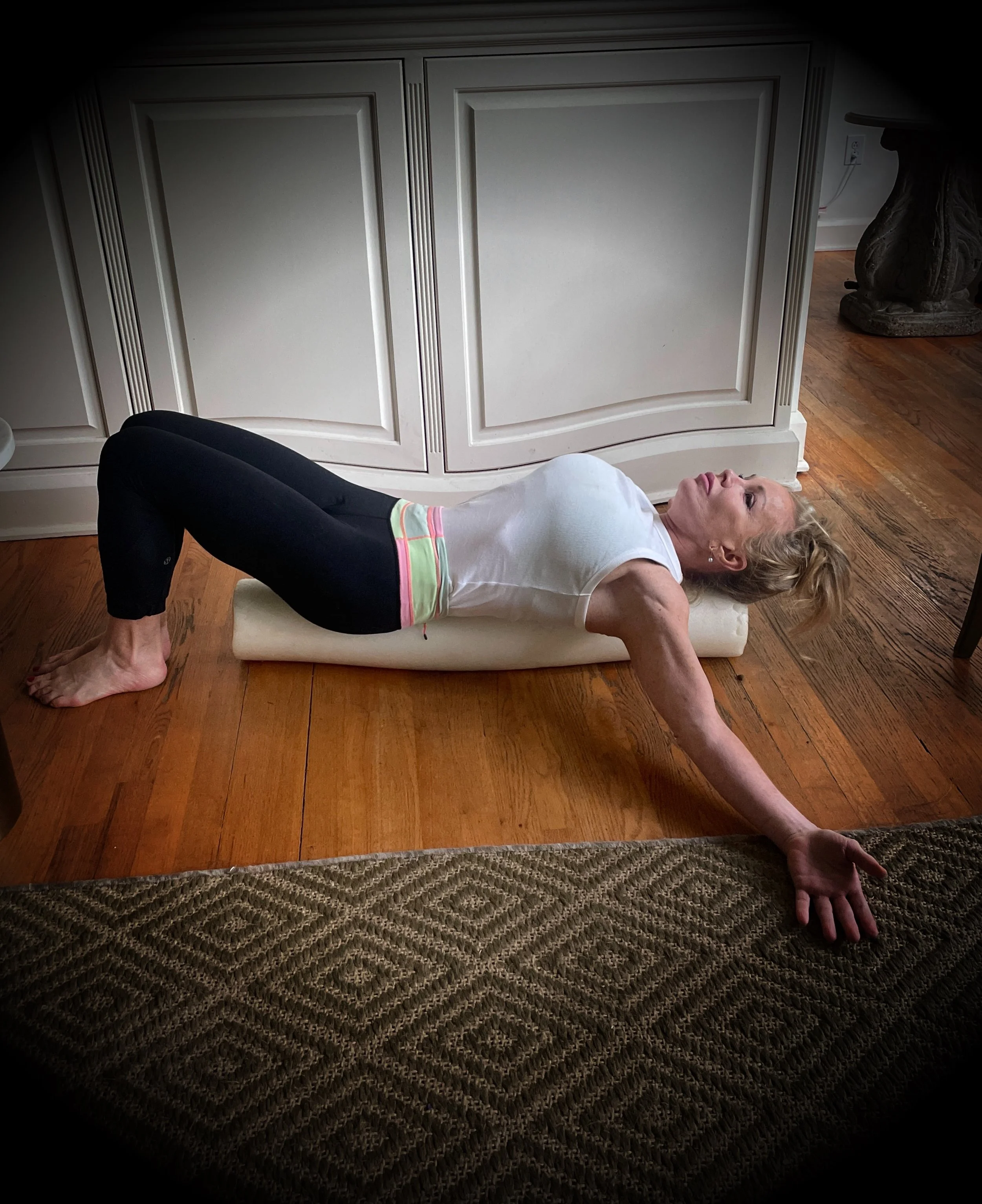 woman stretching back on foam roller