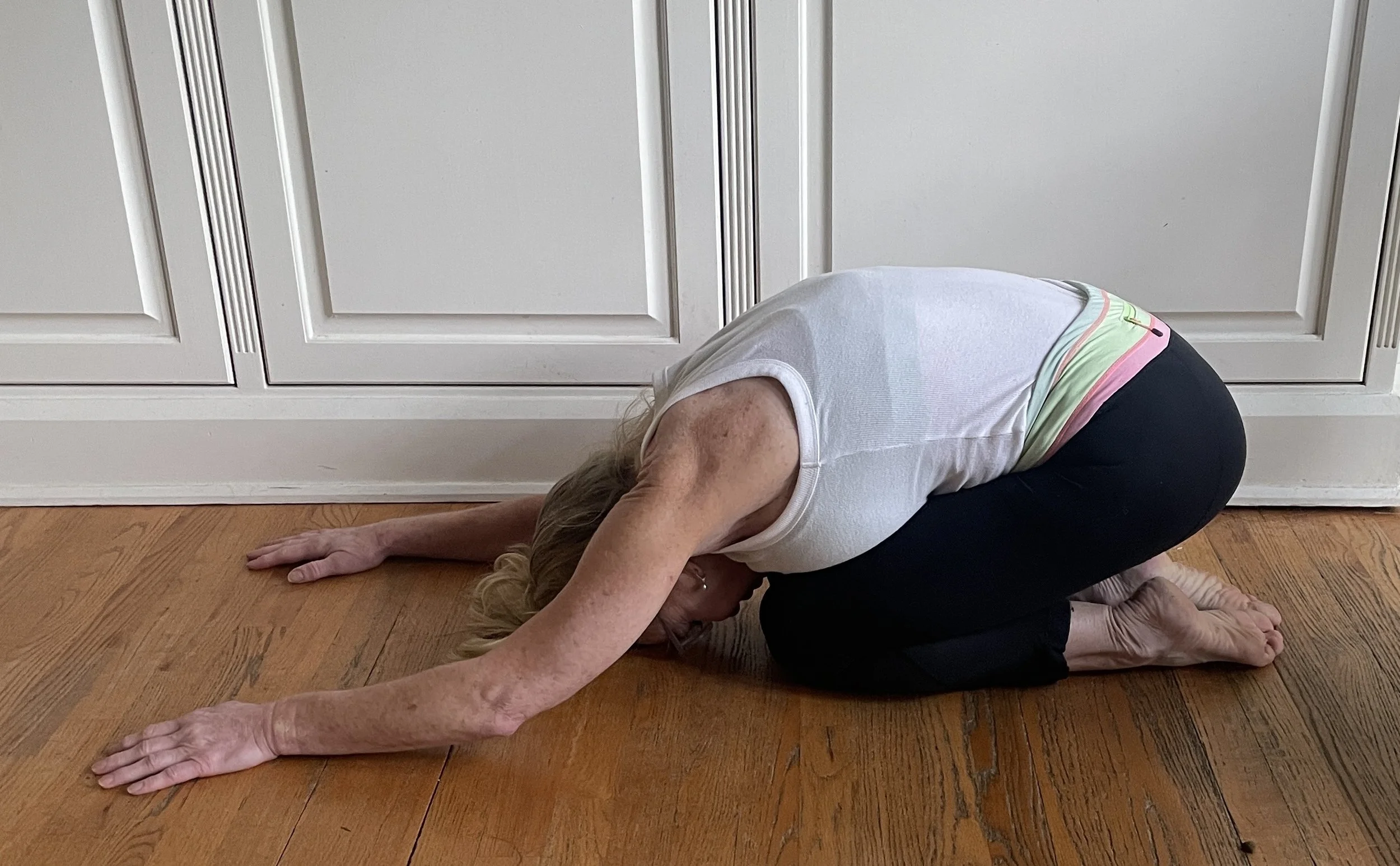Woman in child's pose stretching