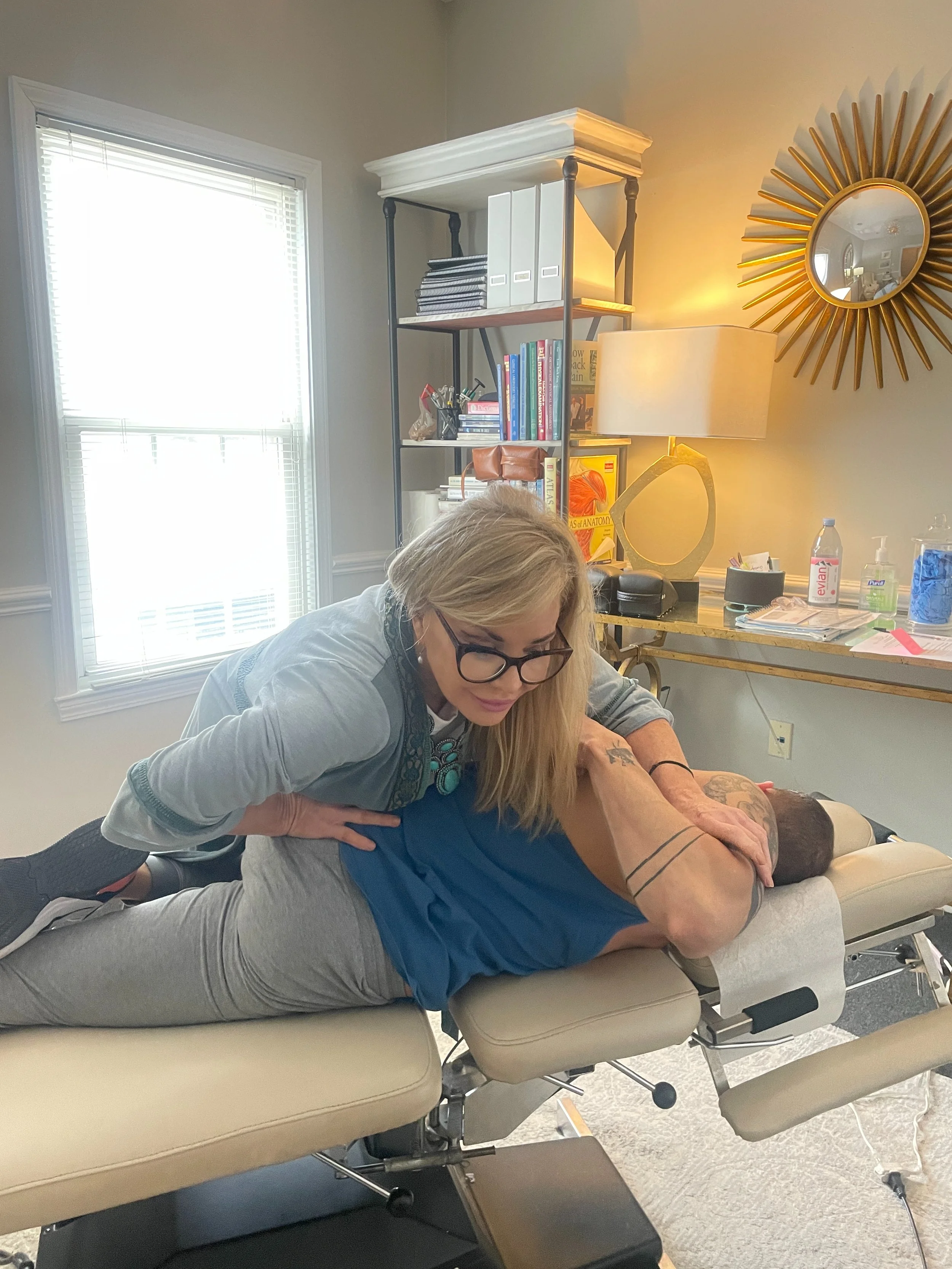 chiropractor adjusting male patient on table