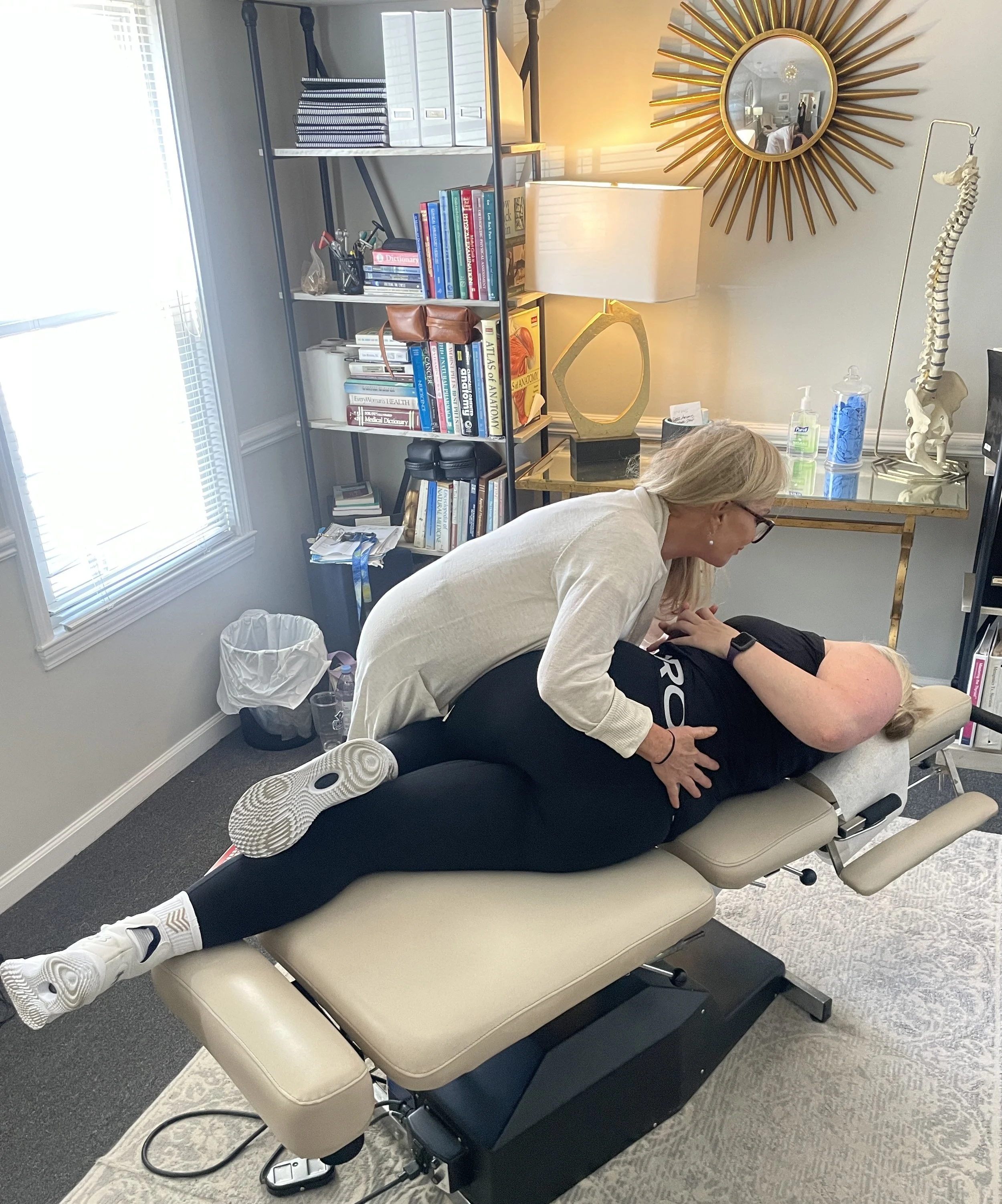 chiropractor adjusting patient on table