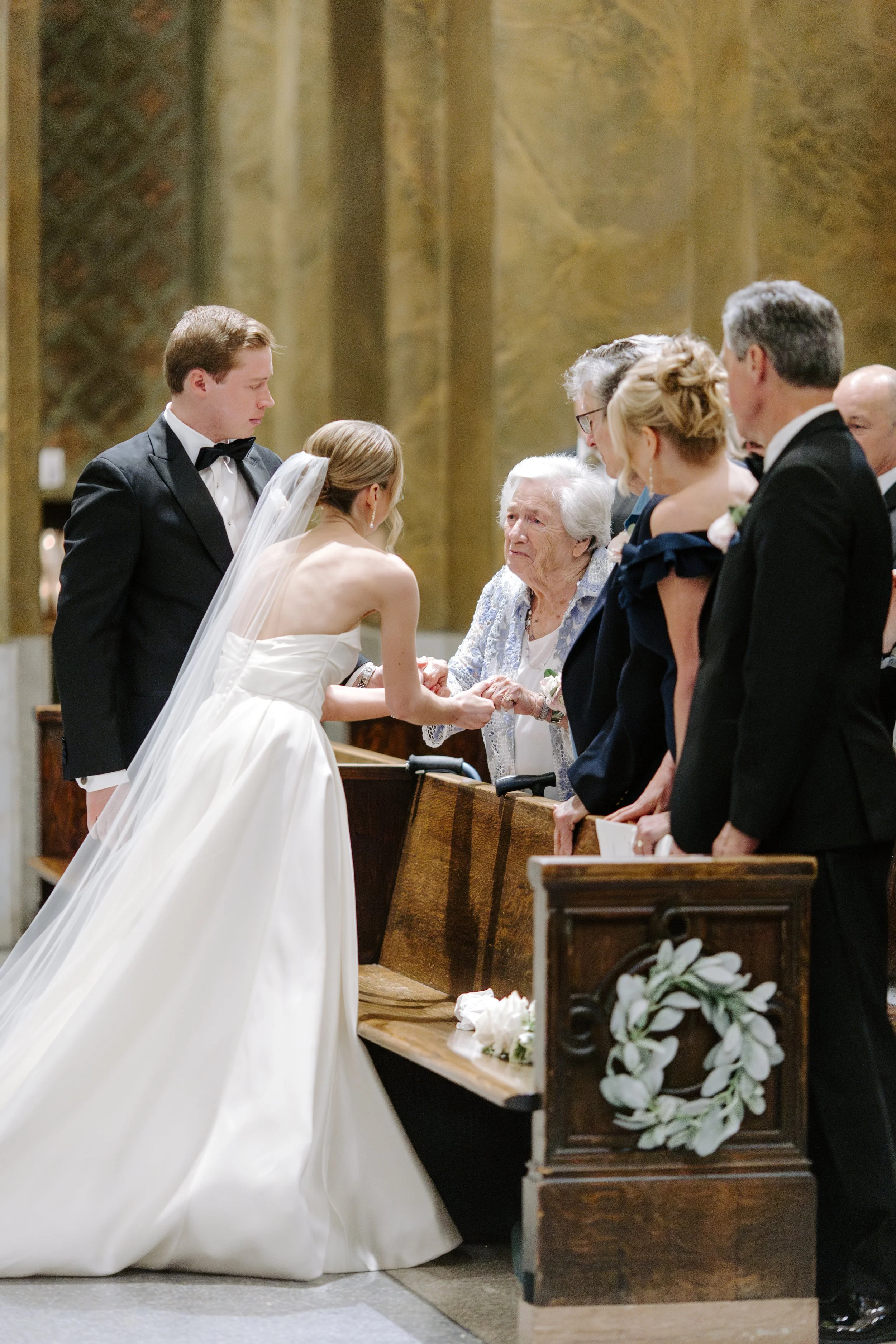 Wedding ceremony with a bride and groom exchanging vows at a church altar, surrounded by family and friends.