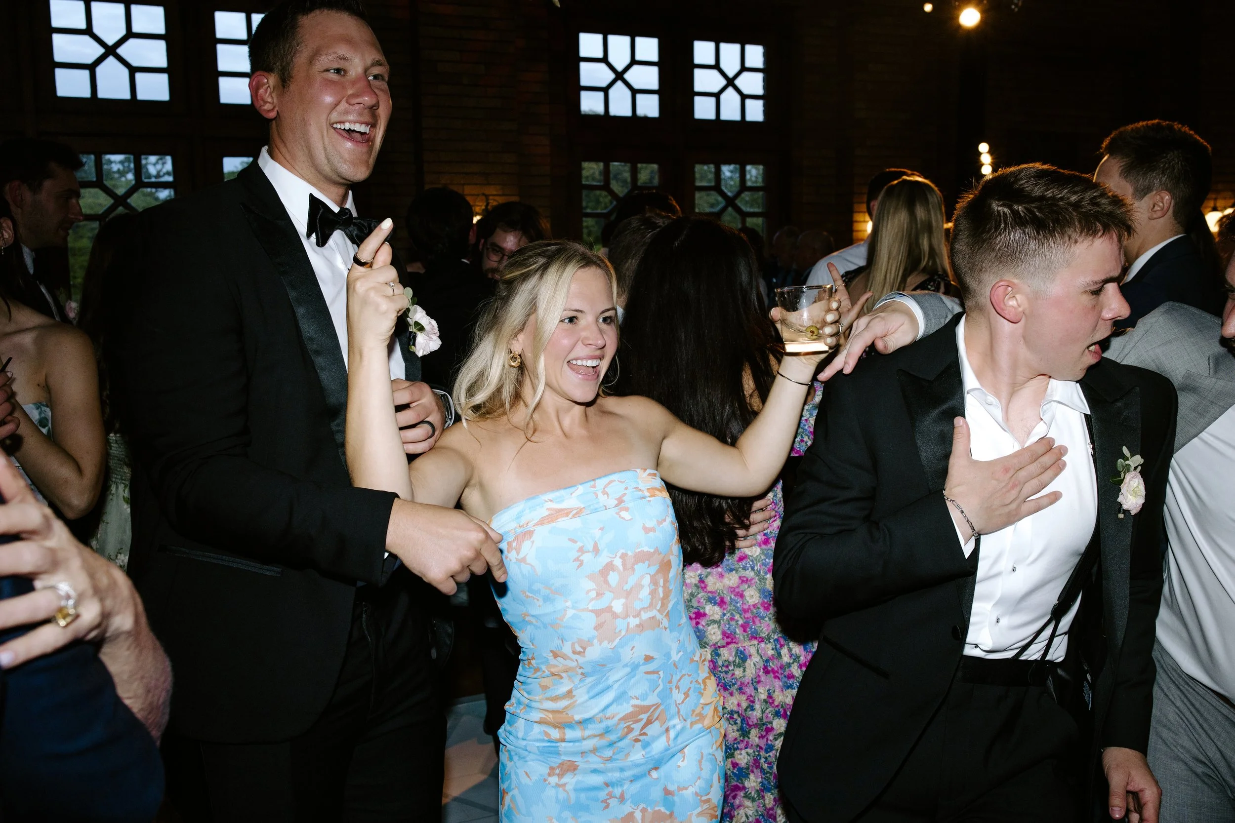 People at a party or celebration, dancing and enjoying themselves indoors.
