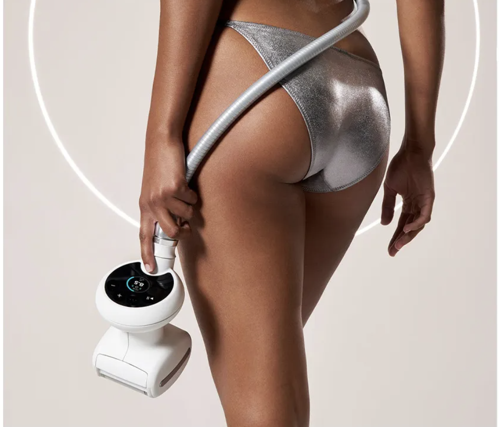 A woman holding a handheld weight loss or body contouring device, dressed in metallic silver underwear, with a glowing circular background.