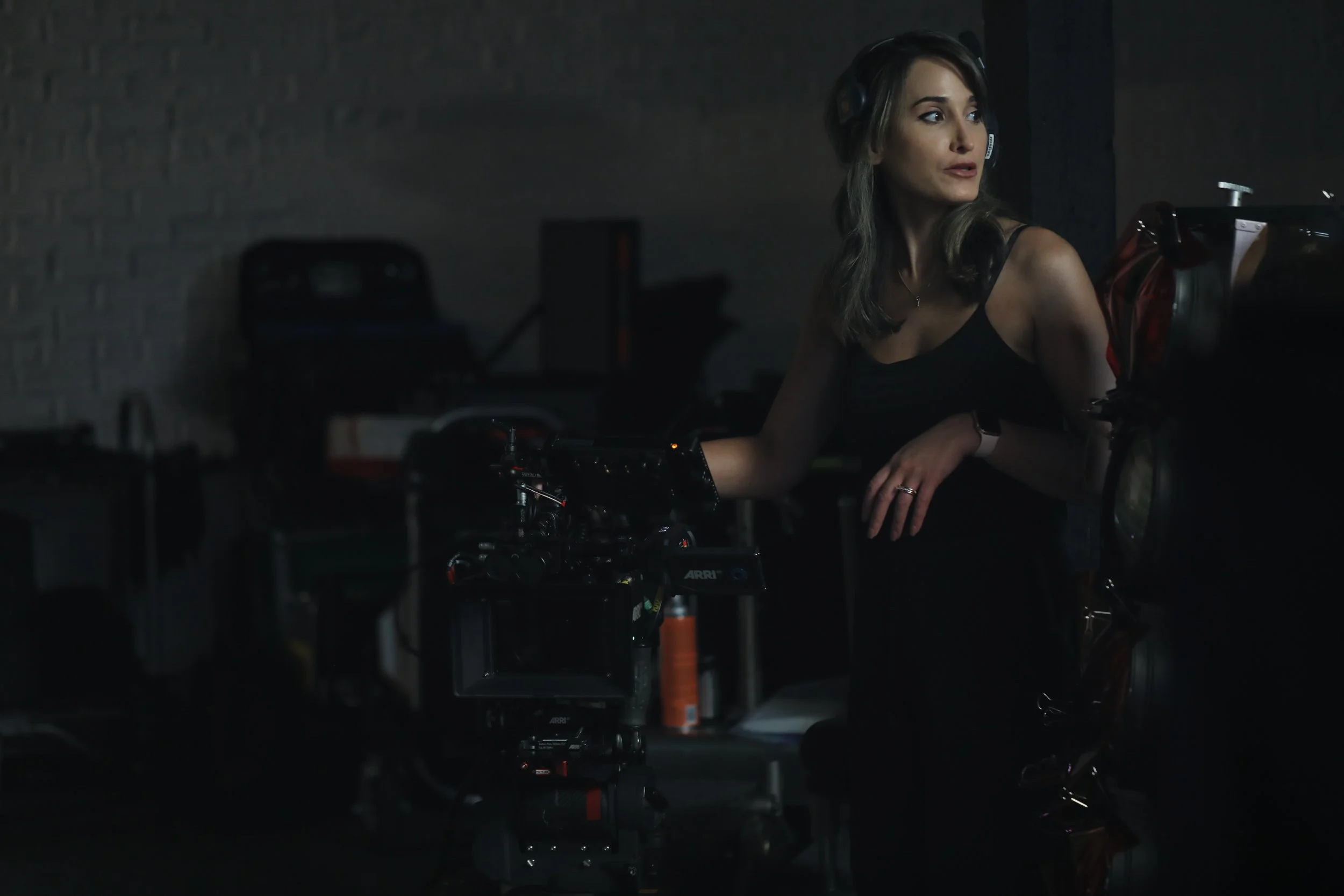 Portrait of cinematographer and director Lara Aqel in a studio surrounded by film equipment.