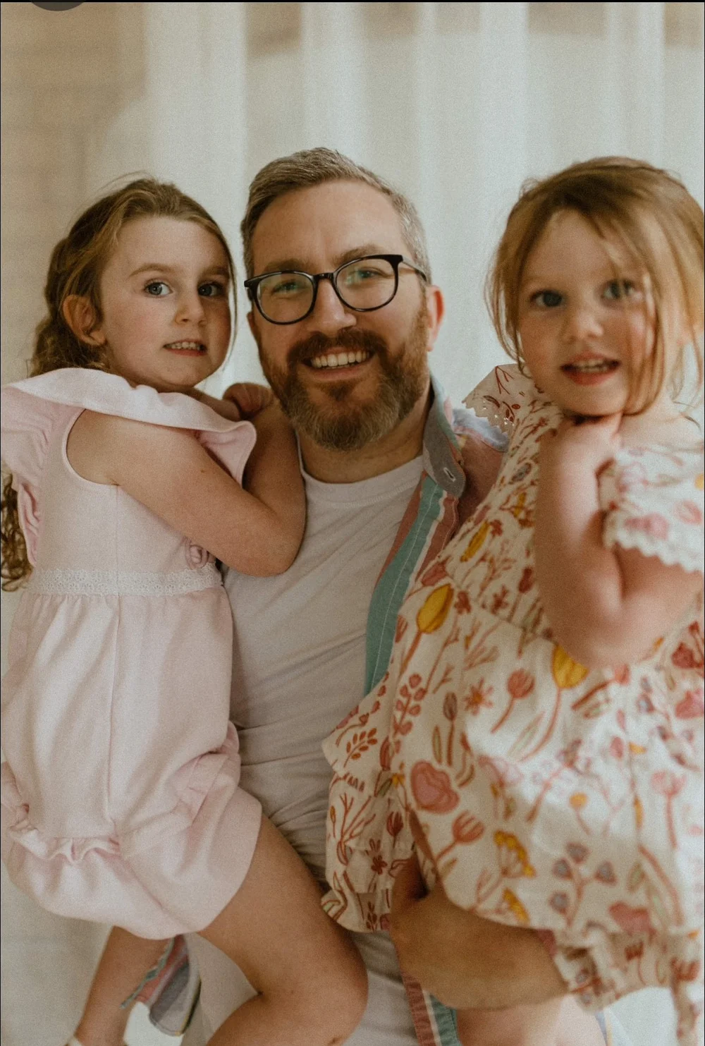Andrew Richey smiling with two of his children