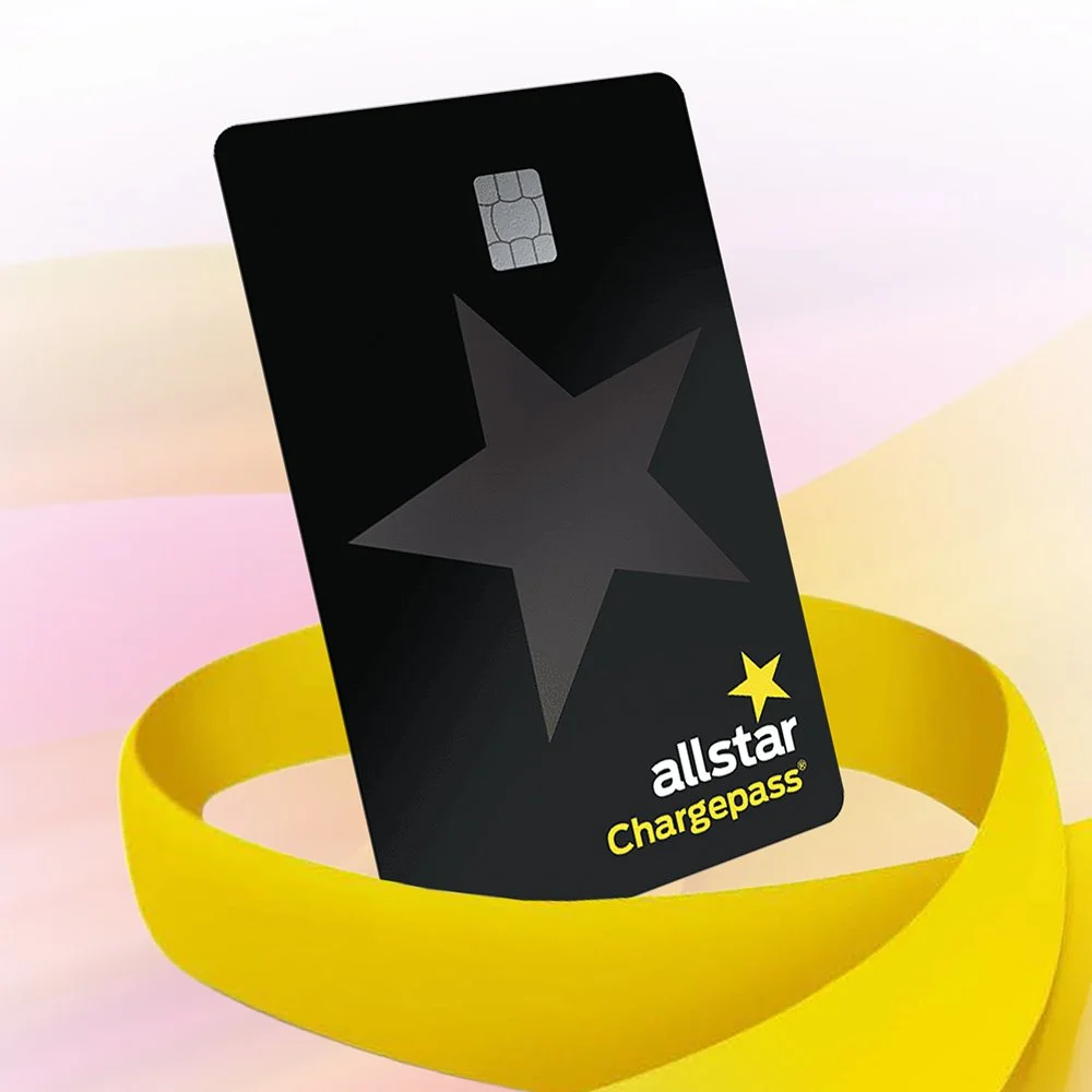 Allstar Chargepass card with a black star design, placed on a yellow wristband against a pastel pink and yellow background.