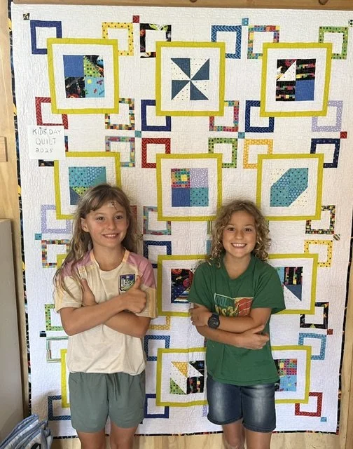 Elm and Odile Burke in front of Kids Day quilt.jpeg
