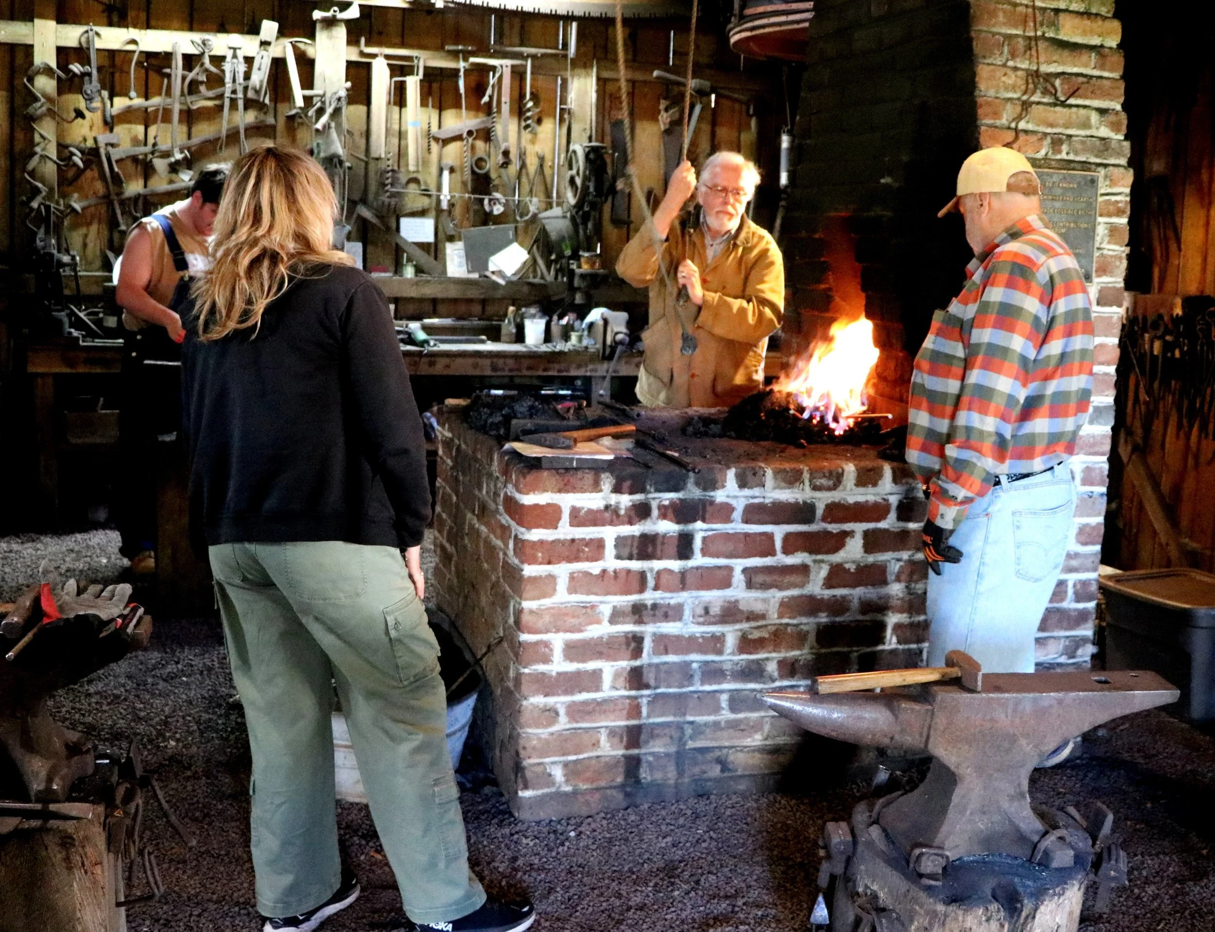 Blacksmith students at the forge bellows.jpeg