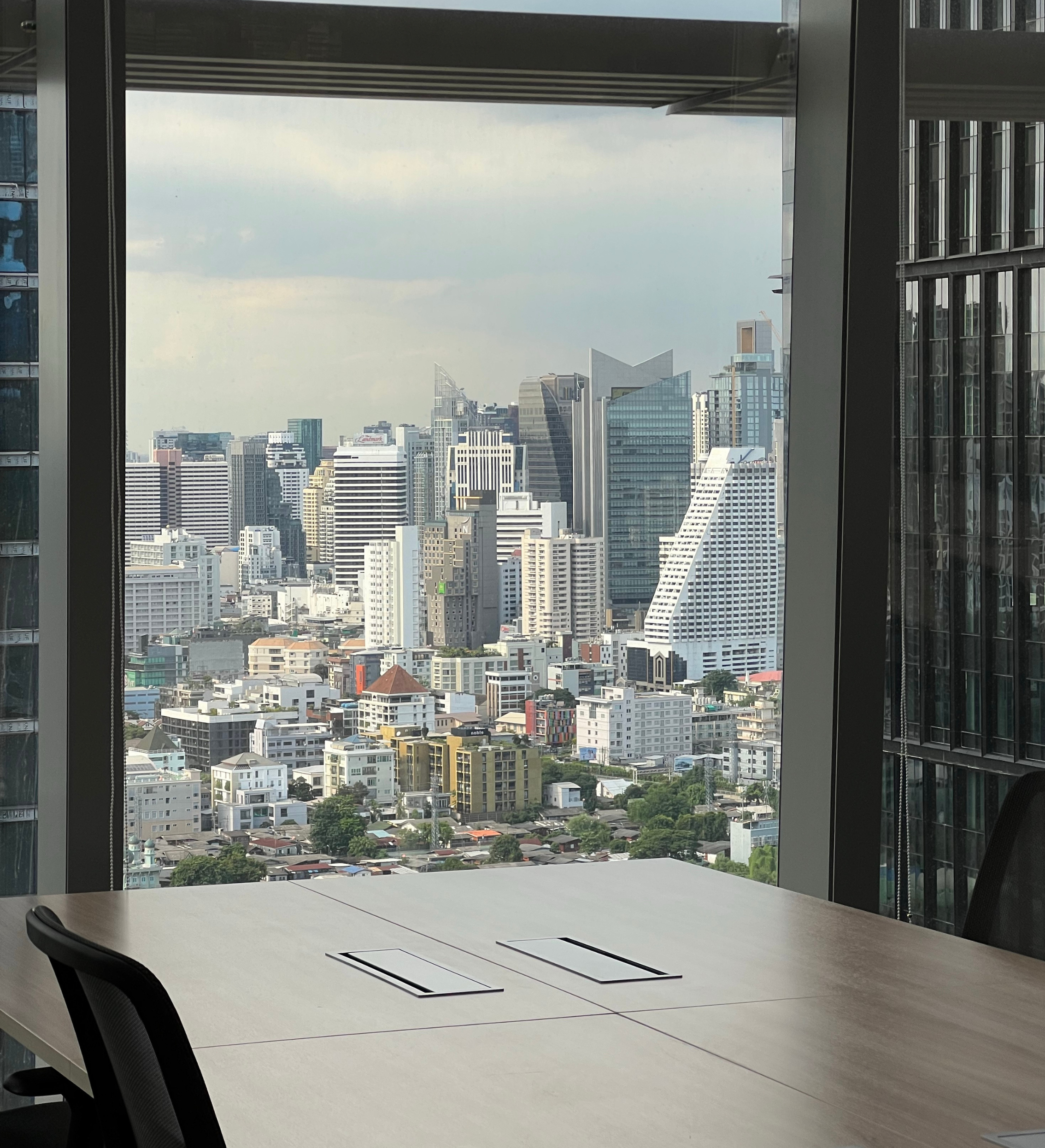 A modern boardroom with floor-to-ceiling windows overlooking a city skyline, representing the senior strategic environment of The Embedded Advisor engagement from True House Advisory.