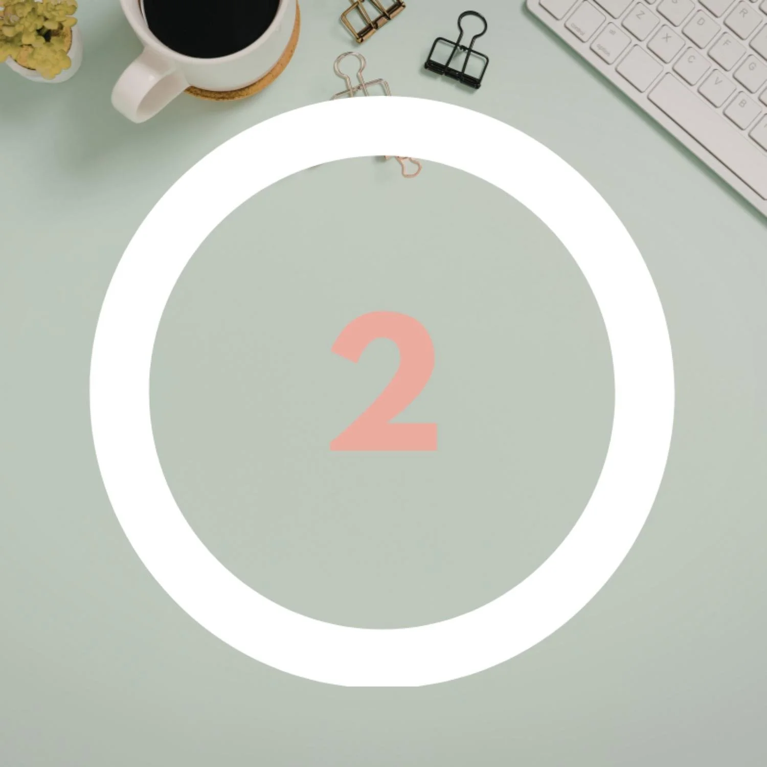 Coffee, keyboard, paperclips on green background with number 2 overlay.