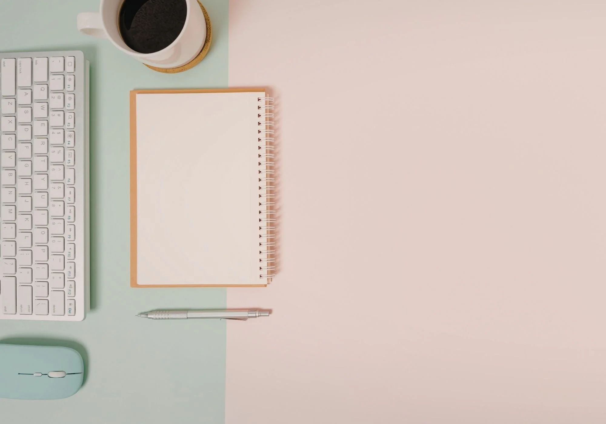 Notepad and pen on pale pink background.