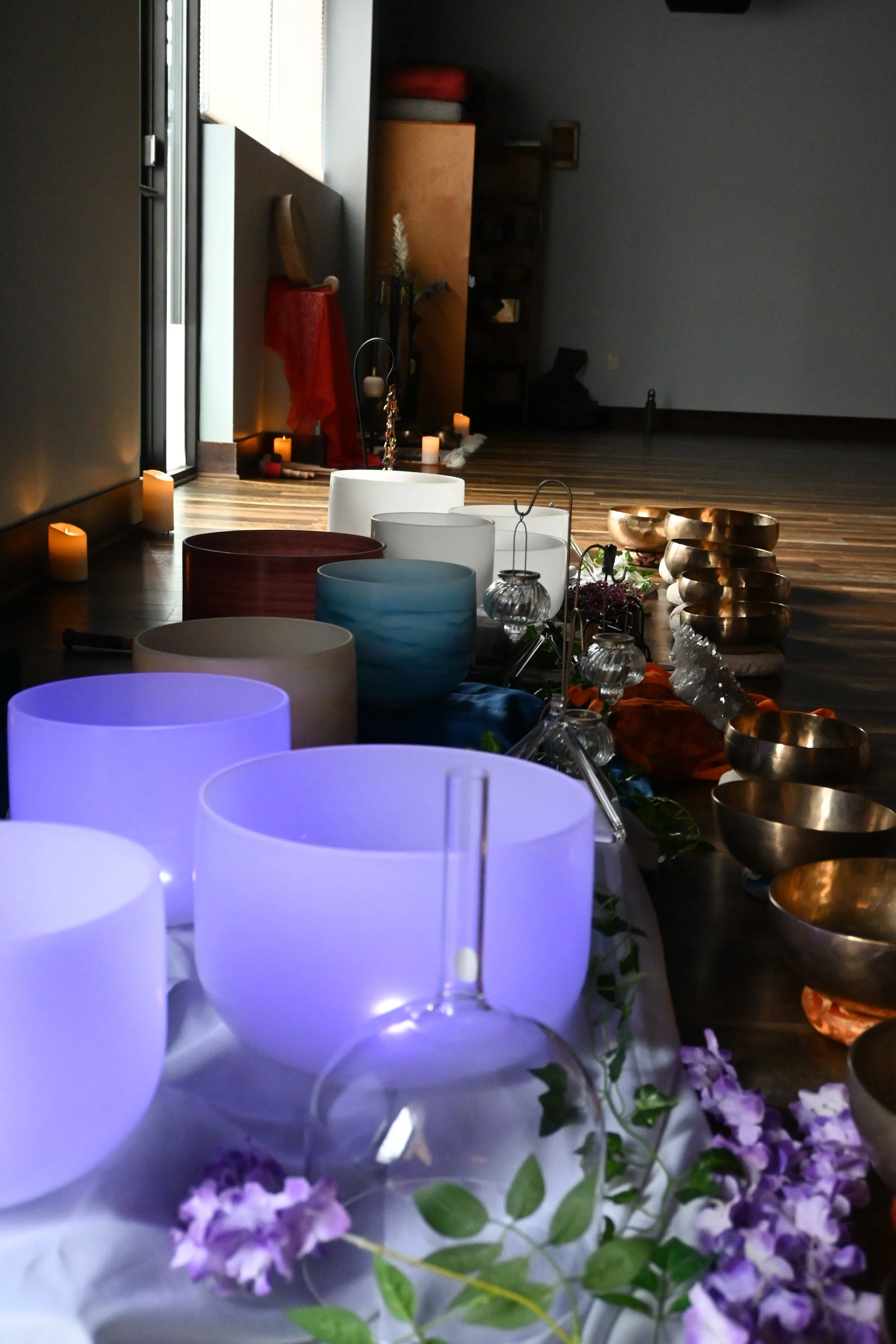 purple lights in sound bowls. Mother Maiden Crone sound bath set up with metal bowls and candles