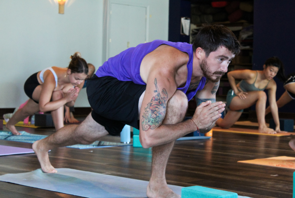 People practicing yoga indoors, in a yoga class. at Thrive Yoga