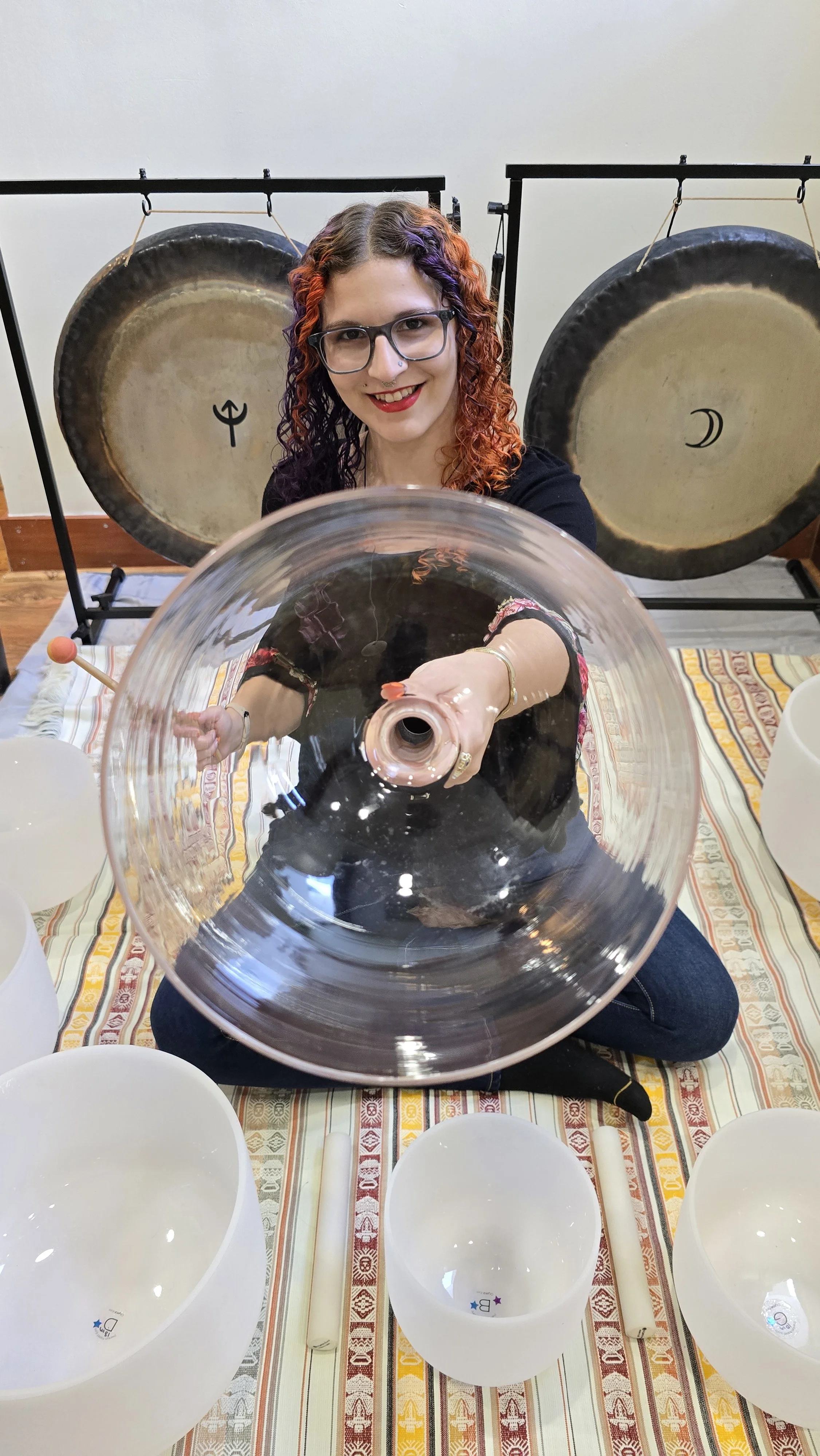 sound instruments including the handheld bowl and the gongs in the background
