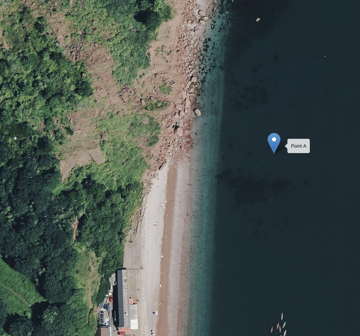 Aerial view of a coastal area with a forest on the left, sandy beach in the middle, and dark water on the right. A marker labeled 'Point A' is placed in the water.
