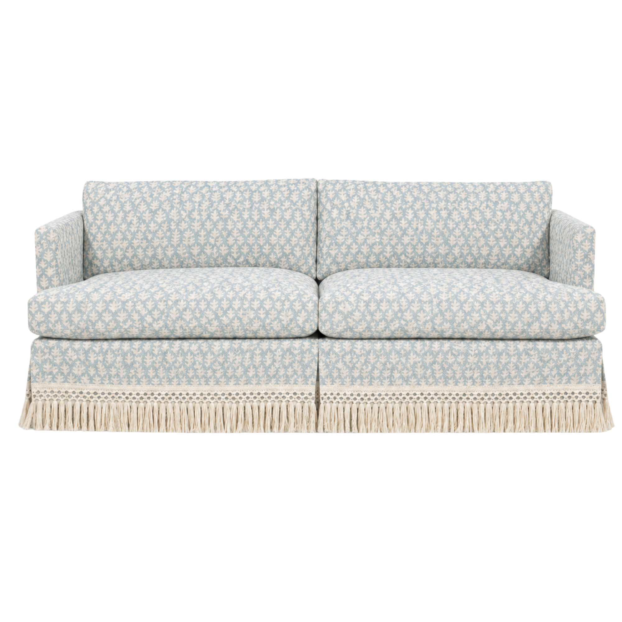 A vintage-style LEE Industries sofa with a blue and white pattern, and custom fringe at the bottom upholstered with LINK textiles.