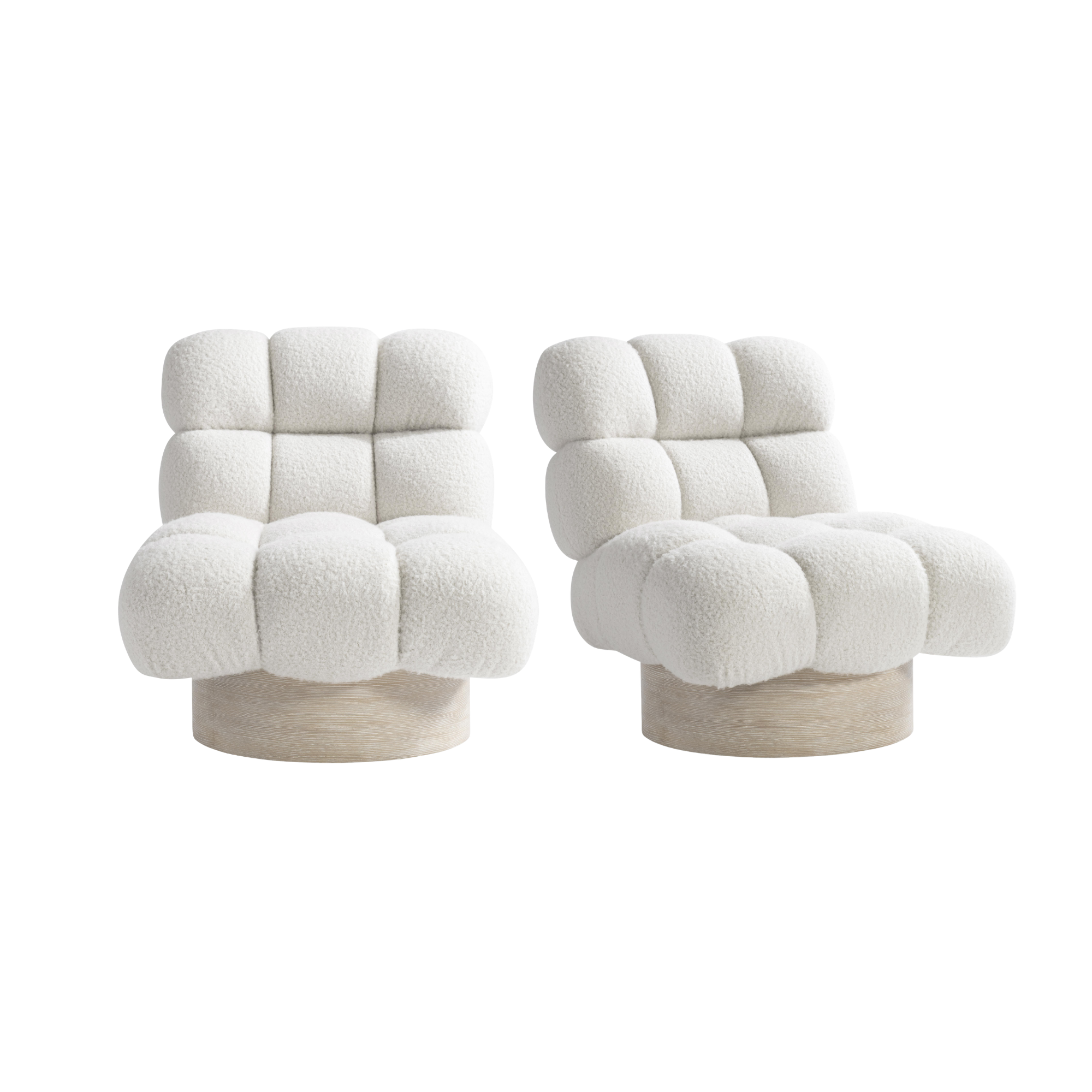 Two modern, plush, beige armchairs with rounded shapes and wooden bases provide custom by bernhardt furniture.