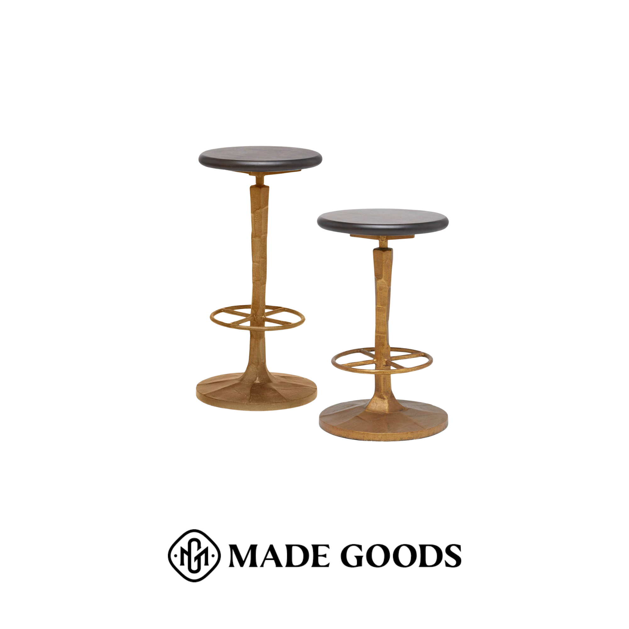 Two wooden stools with dark round seats and circular footrests against a white background, sourced from Made Goods.