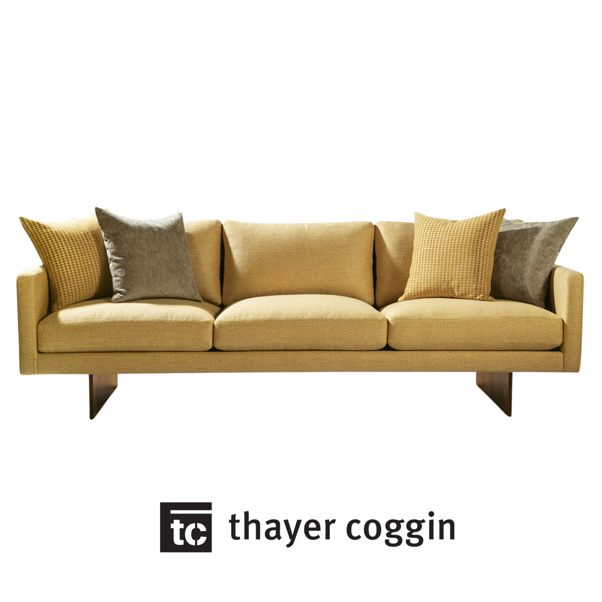 A yellow sofa with a variety of gray and yellow checkered and solid throw pillows, against a plain white background made by Thayer Coggin.