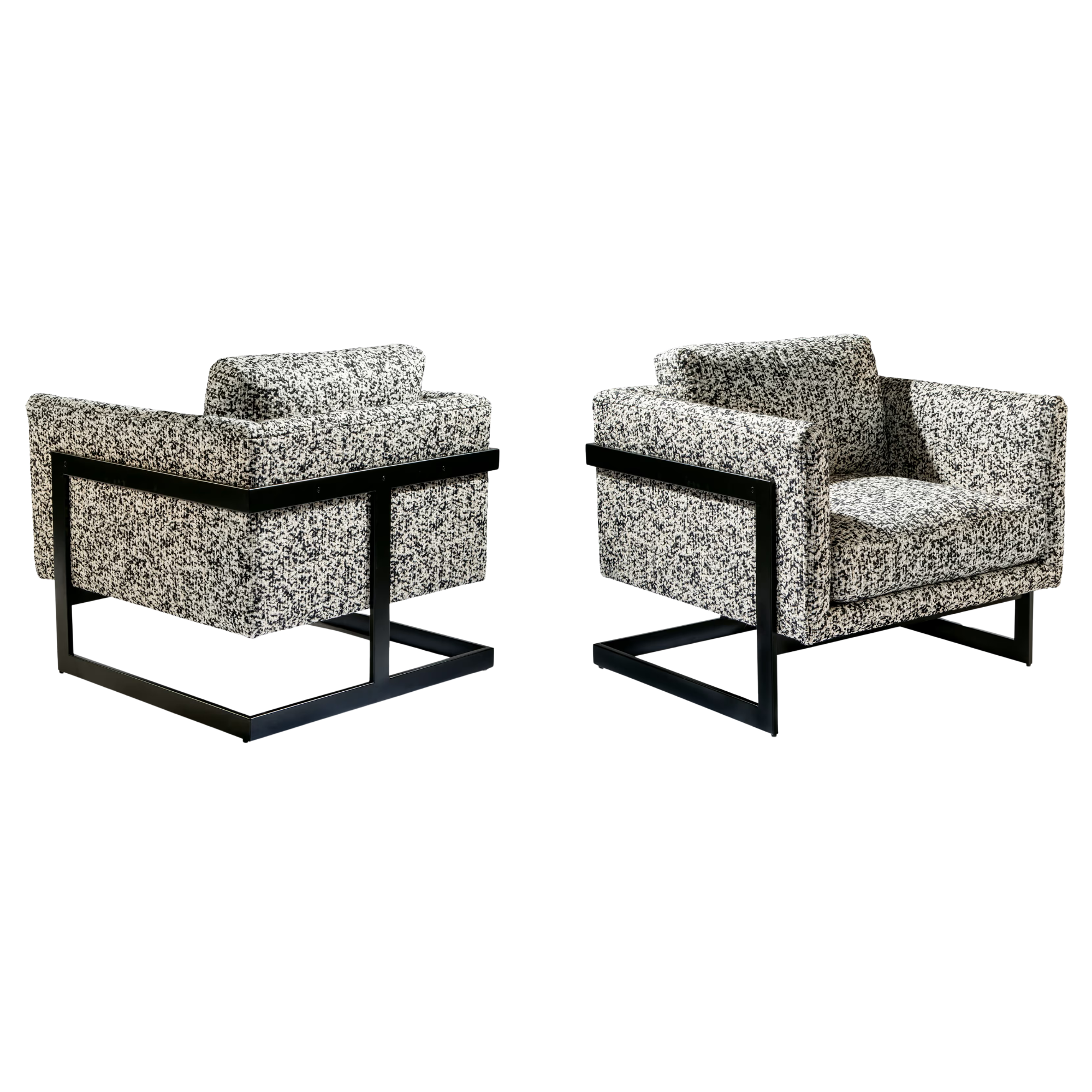 Two modern armchairs with black metal frames and patterned fabric upholstery custom made by thayer coggin.