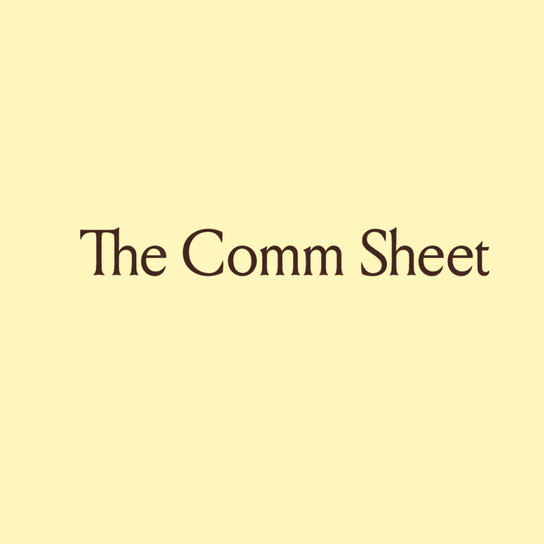 Part of a logo or sign with a light yellow background and dark brown text that reads 'The Comm Sheet' and 'view'. The image is cropped, showing only a section of the full design.