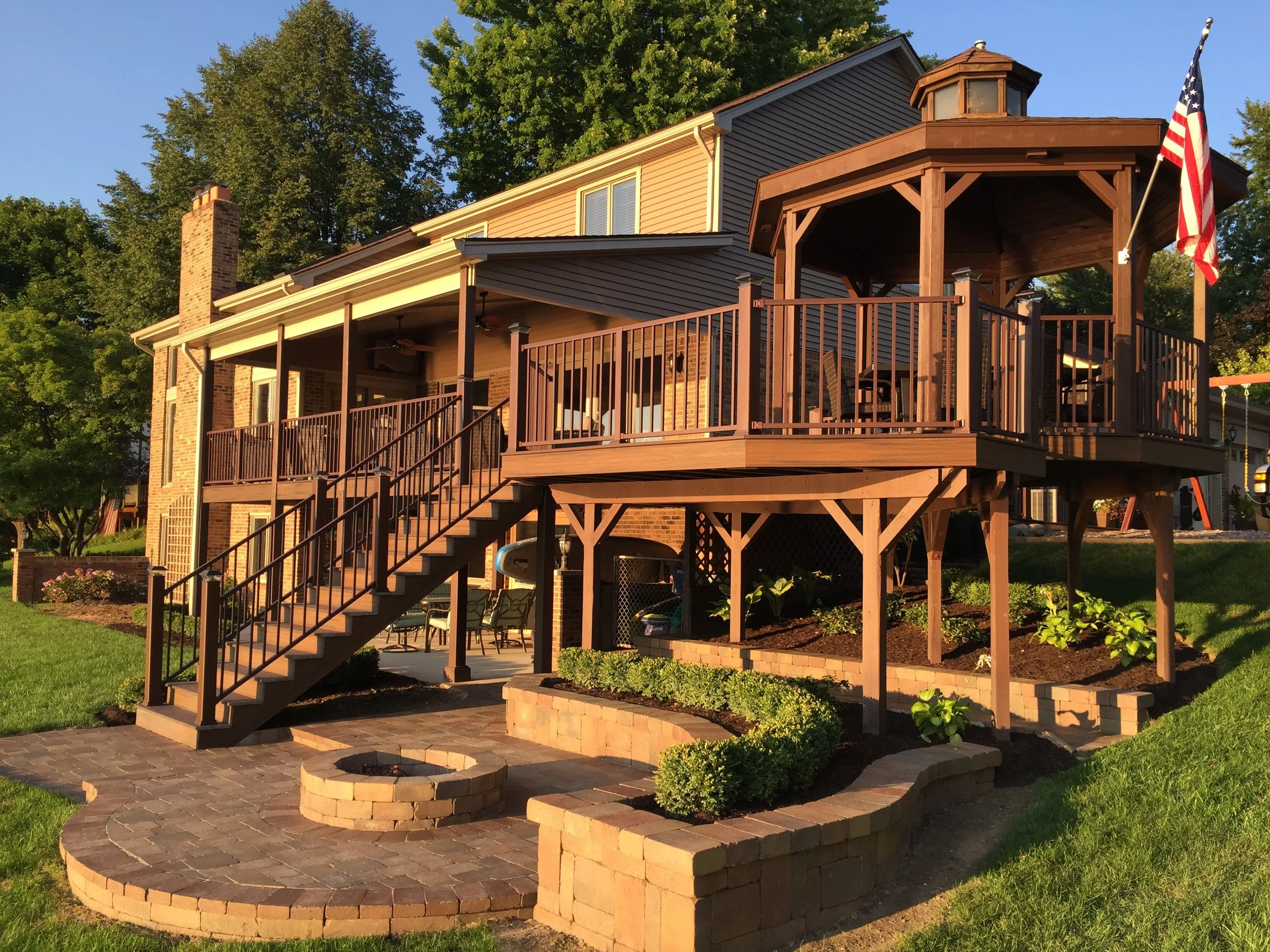 Michele Lane rear elevation.  Work included new brick pavers with seating area and gas fed fire pit, new landscaping.