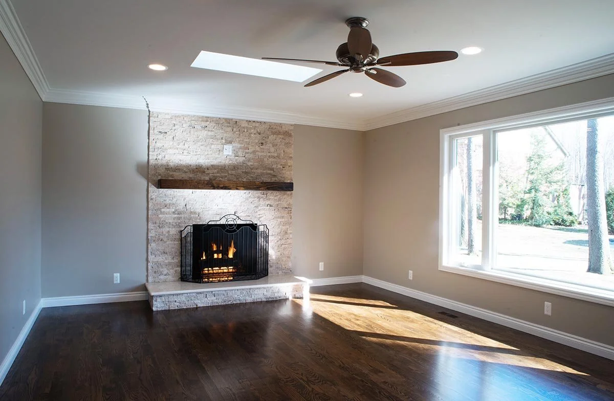 Breza Family Room elevation included: new sky lights, new hardwood floors, new dry stacked stone fireplace surround, new barn wood timber mantle, new crown and base moldings, etc.