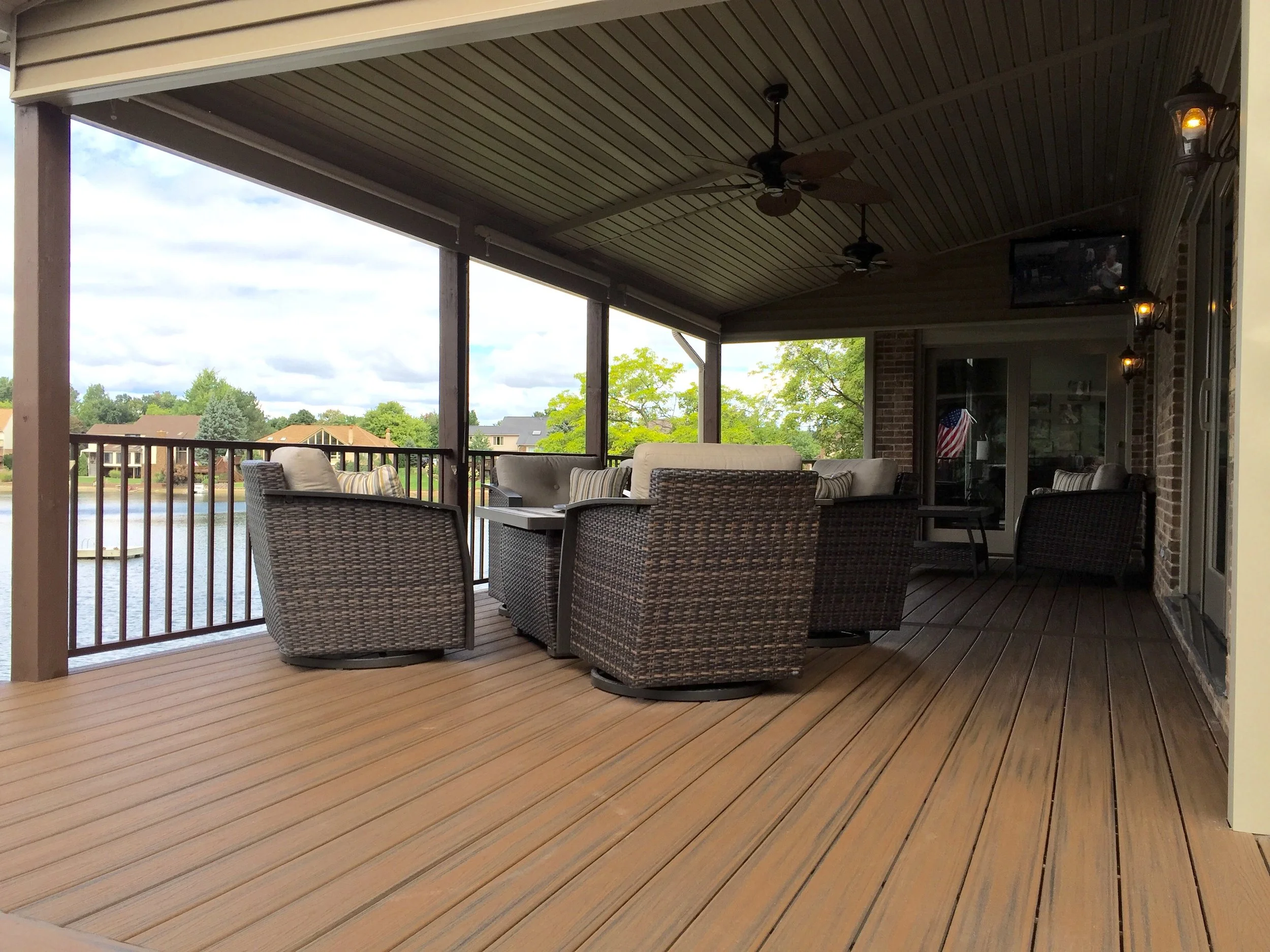 Michele Lane covered porch (outside family room). Work included removing existing porch walls, reframing new openings, new vinyl covered ceiling, new Trex decking and railings, installation of new ceiling fans and television.
