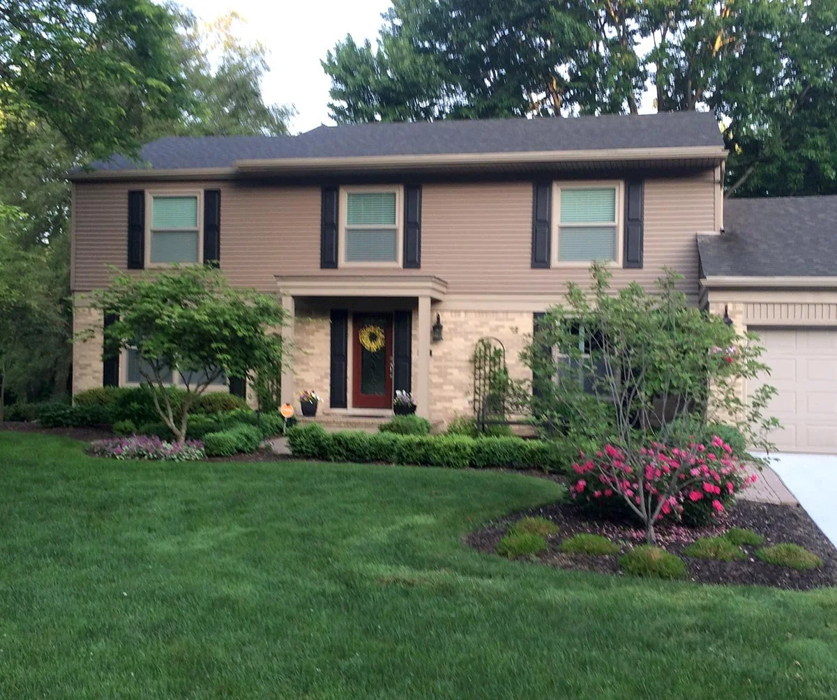 Complete interior and exterior renovation. Exterior work included: installing front porch roof and columns, new Andersen windows, new vinyl siding and aluminum trim, new concrete driveway, new landscaping.  Shady Hollow, Bloomfield Township, MI.