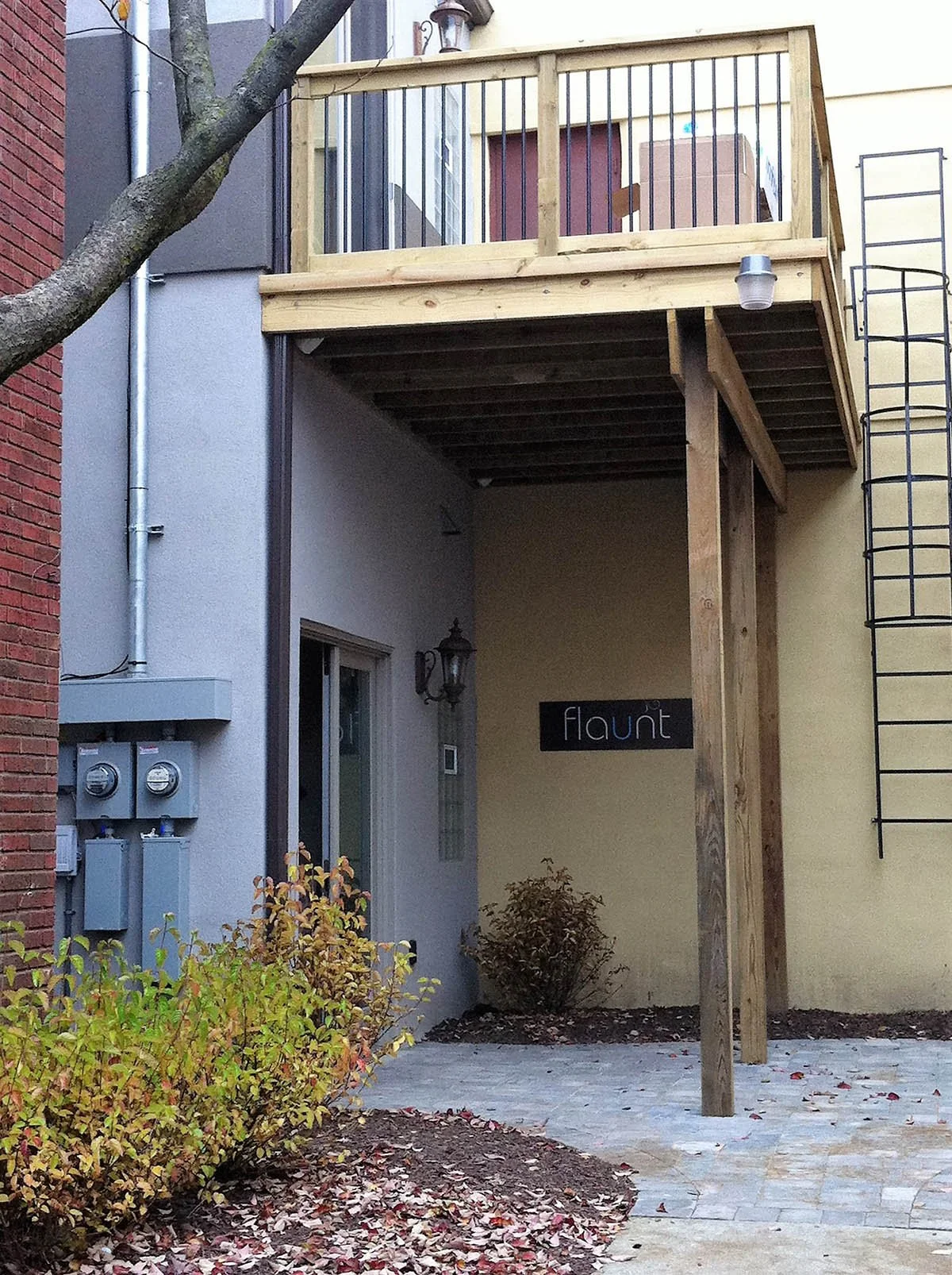 Flaunt Salon rear courtyard.  Work completed included: new second floor egress deck, new wall Dryvit, new pavers, new landscaping. 
