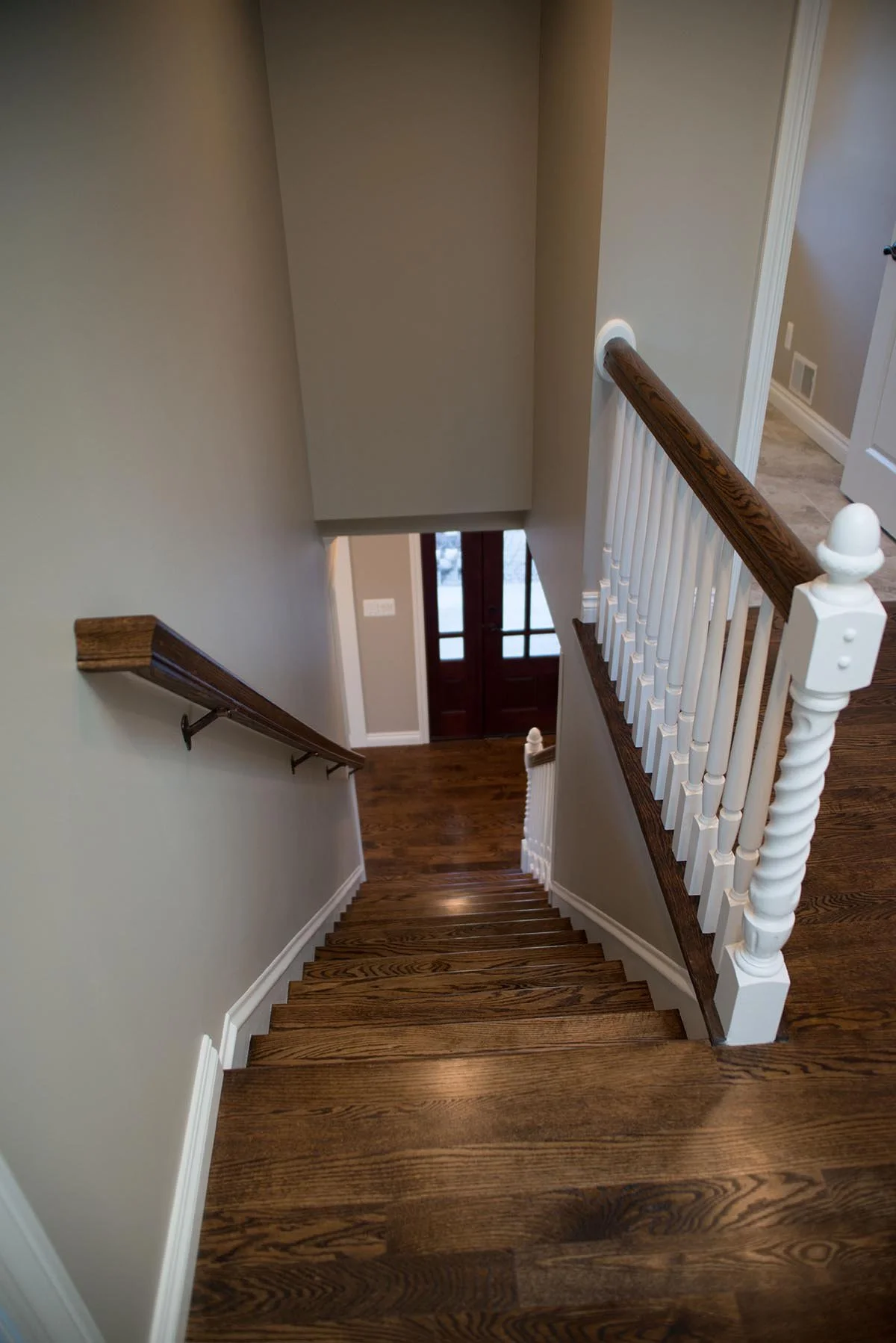 Breza stairway included oak hardwood flooring and stair treads, new enamel white painted risers and balusters, new beveled glass front entry door, etc.