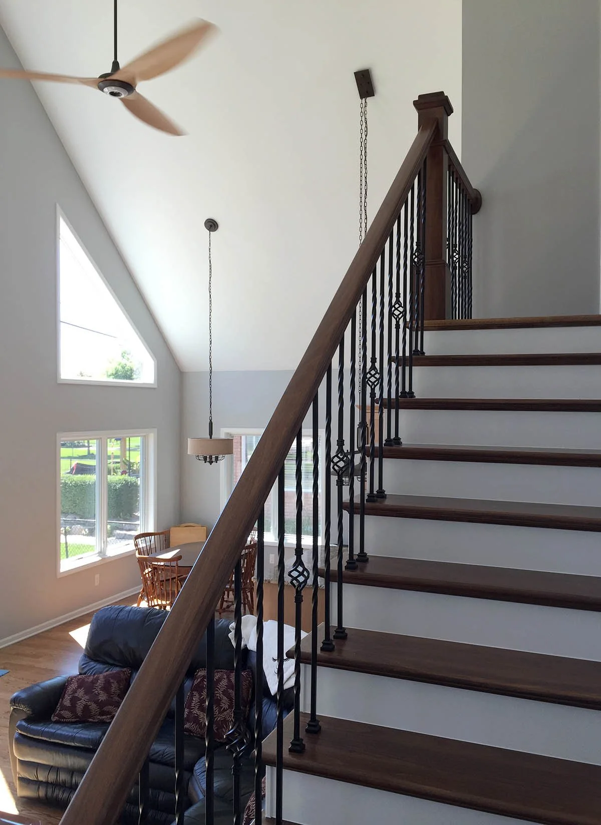 Old North River stairway work included: oak hardwood flooring, oak treads, handrail and newels, white enameled painted risers, metal balusters with basket accent.