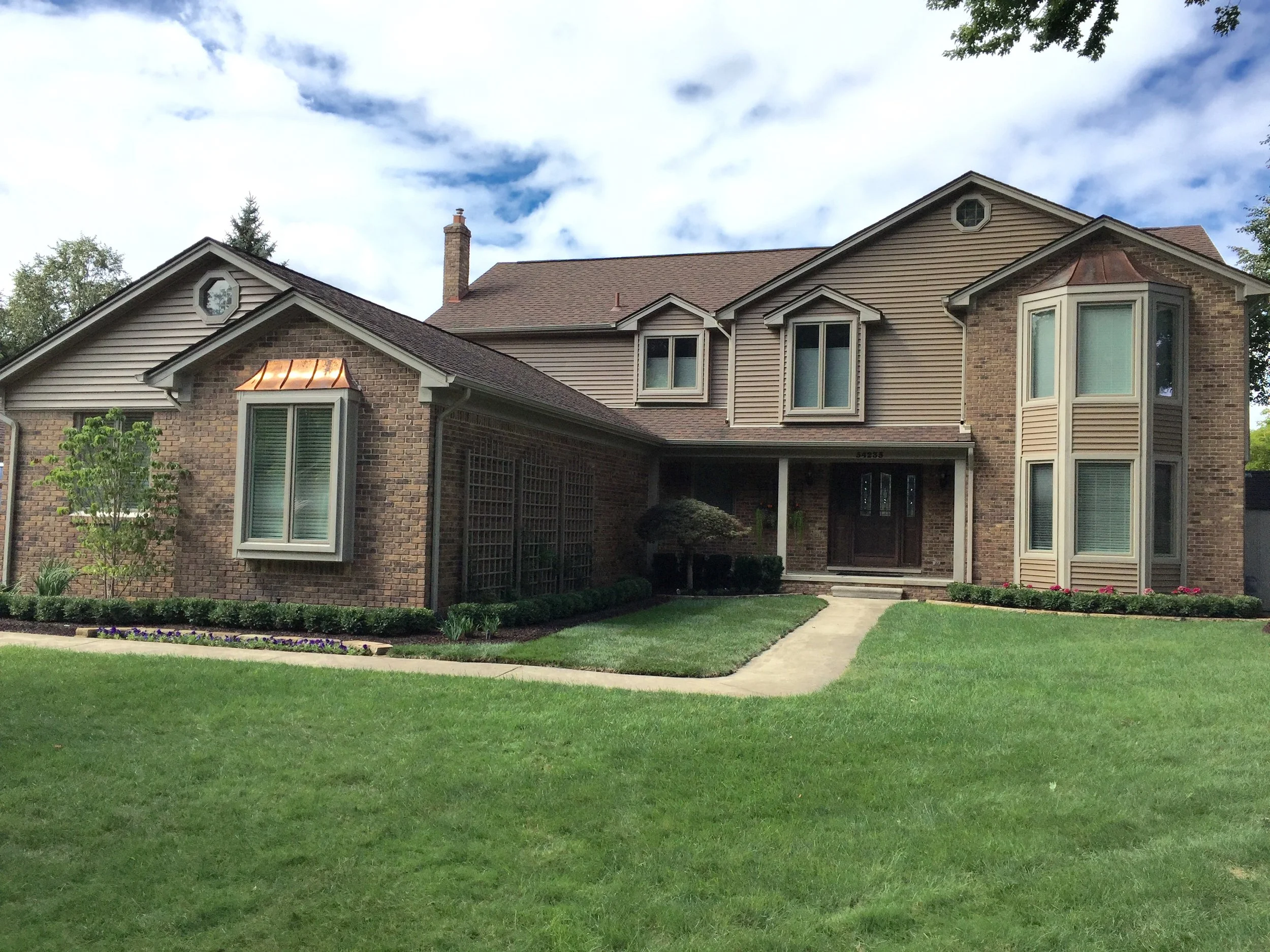 Complete exterior renovation. Work included: new Pella windows, new vinyl siding and aluminum trim, new landscaping.  Michele Lane, Shelby township, MI.