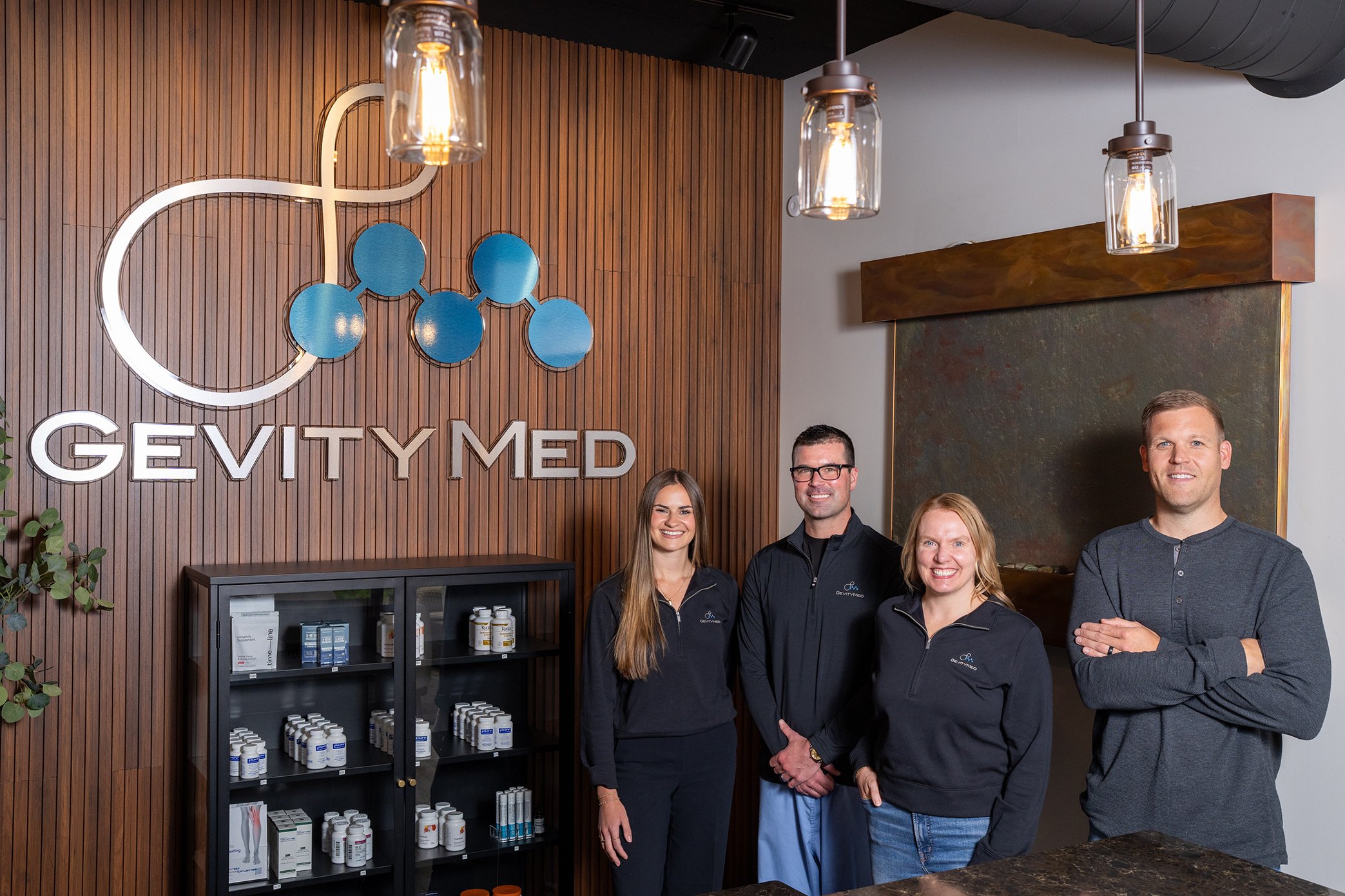 GEVITY MED team members standing, signage, front office, left to right: Lucy Sherman, Dr. Dave Williams, Lucy Sherman, Val Reddy, Tommy Olsen