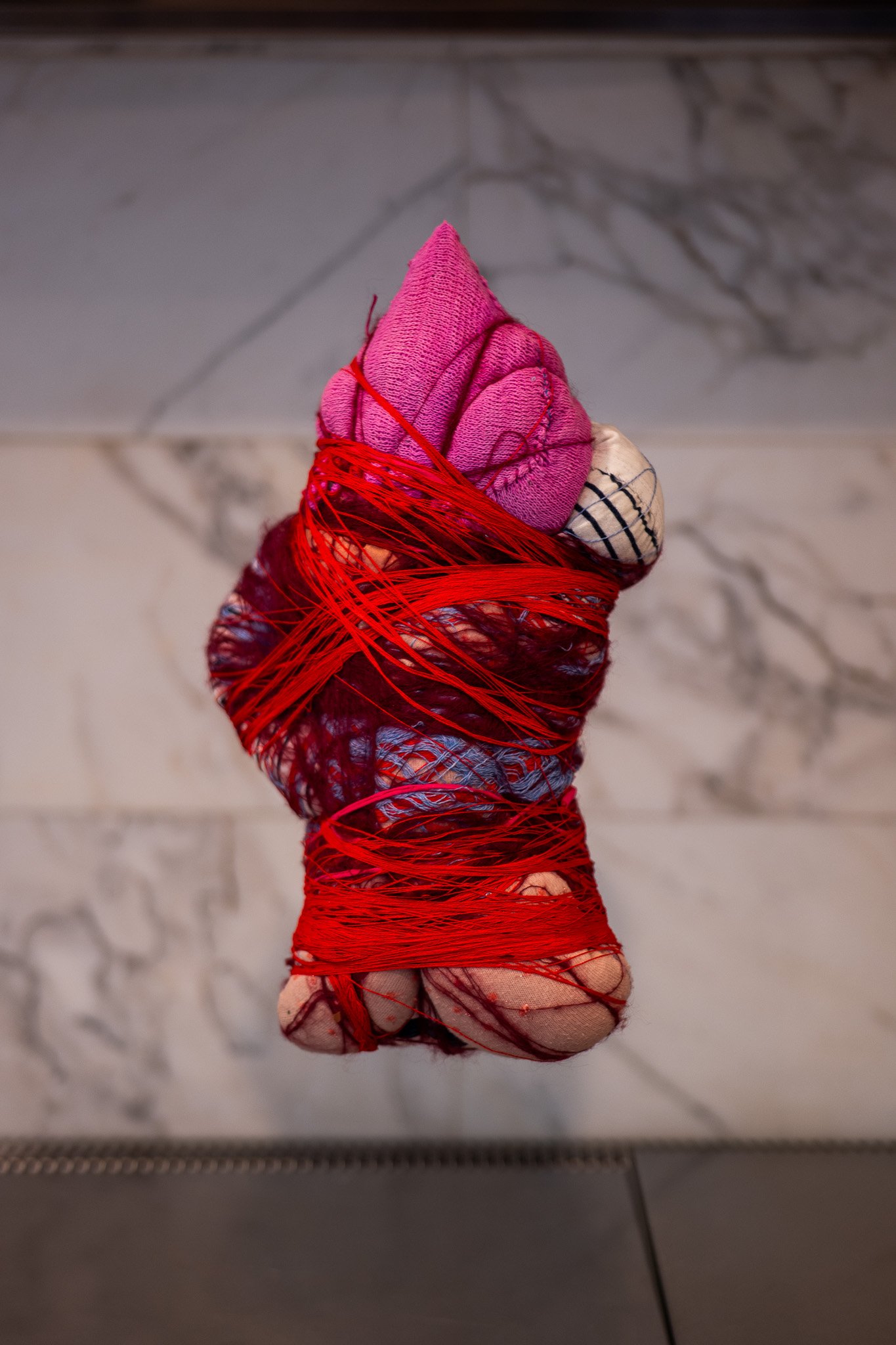 Cocoon, 2023. Textile and red cotton thread - dimensions variable