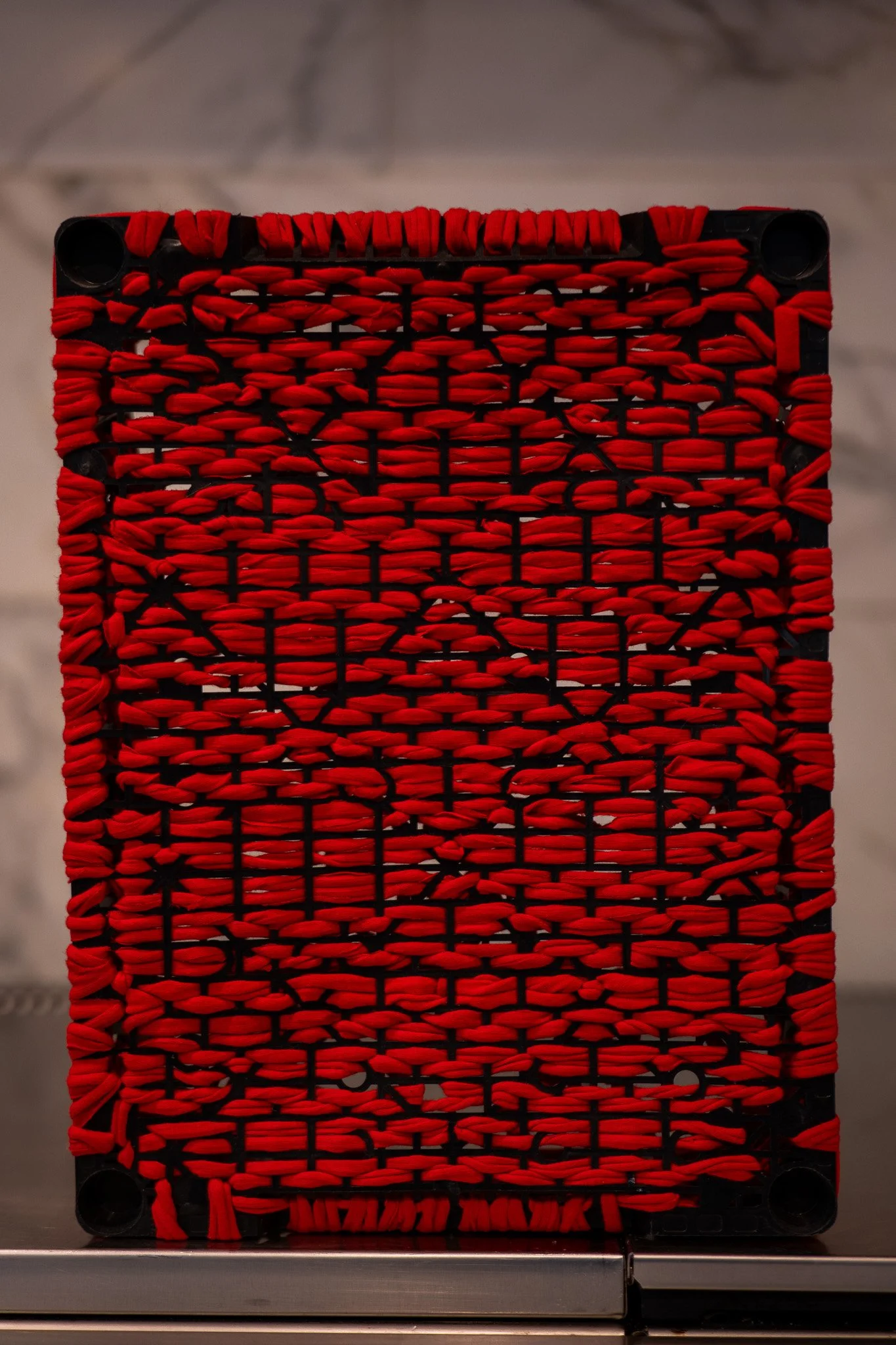 Untitled, 2023. Found object and red cotton thread - 39 x 30 x 8 cm / 15.3 x 11.8 x 3.1 inches