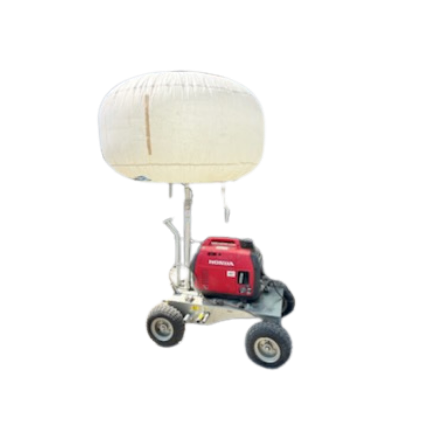 A mobile medical or laboratory device with a large white spherical component on top, attached to a red and black Honda generator on wheels.